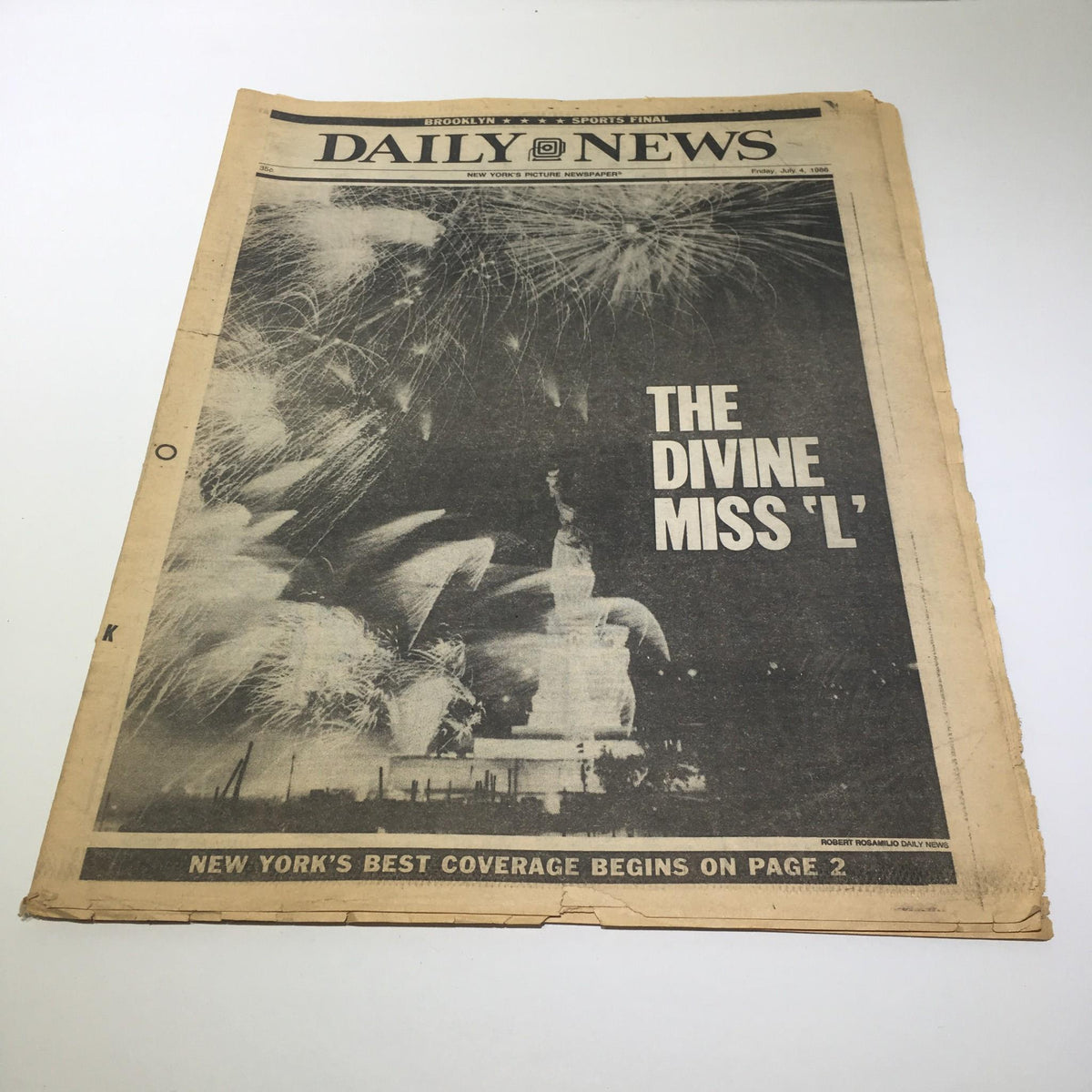Front page of the July 4, 1986 Ny Daily News featuring the headline 'The Divine Miss 'L' and an image of fireworks illuminating the refurbished Statue of Liberty.