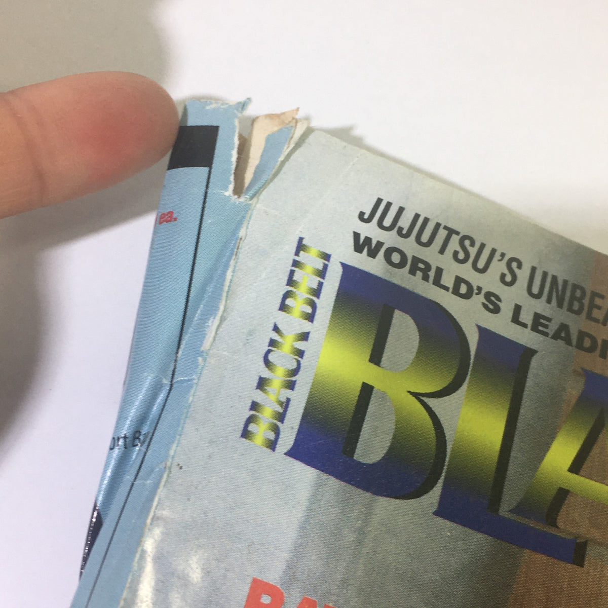 Detail of the spine of the Black Belt Magazine August 1995 showing wear and tear, indicative of its vintage status as a collectible.