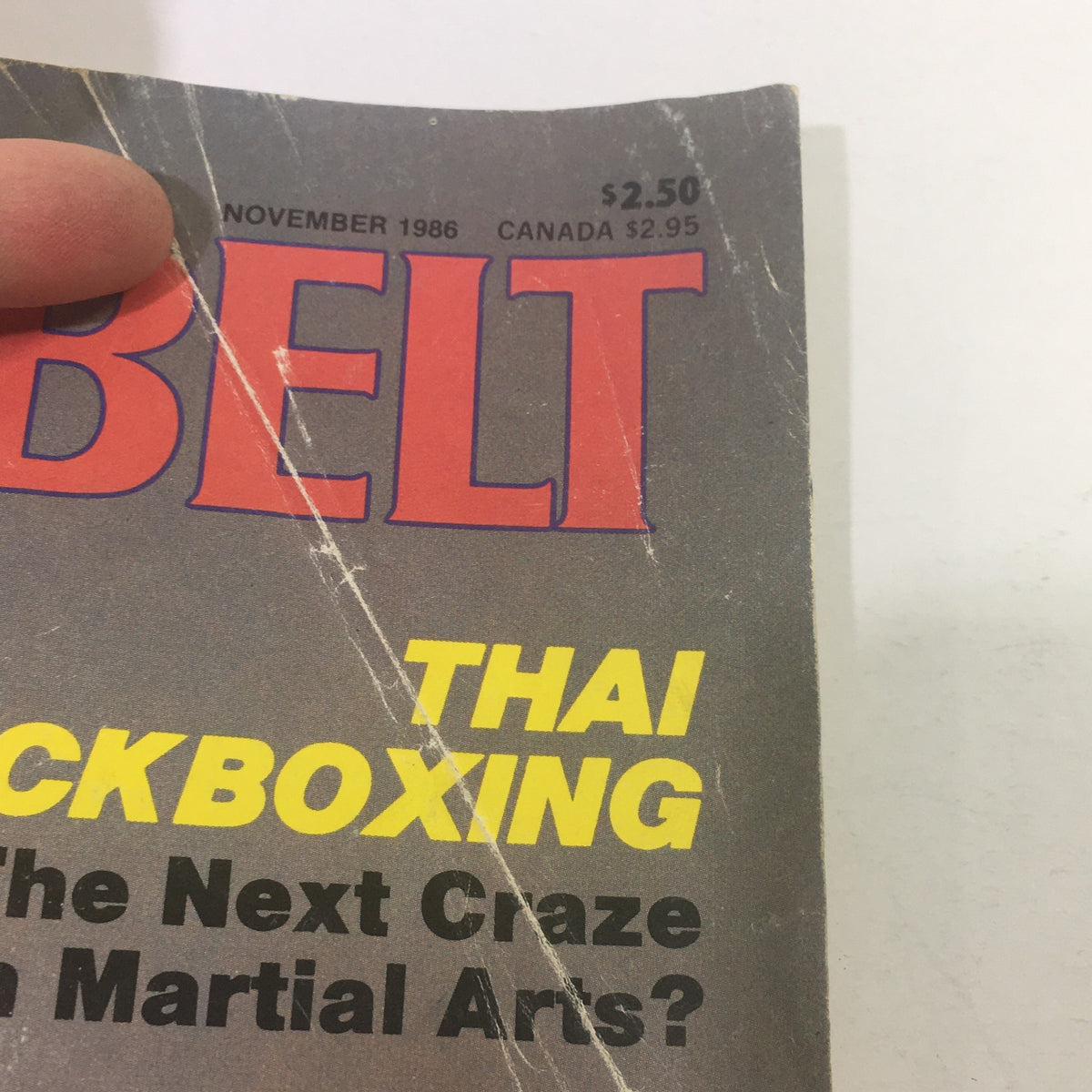 Top section of the vintage VTG Black Belt magazine from November 1986 showcasing the title and details about Thai kickboxing, marking its significance in martial arts history.