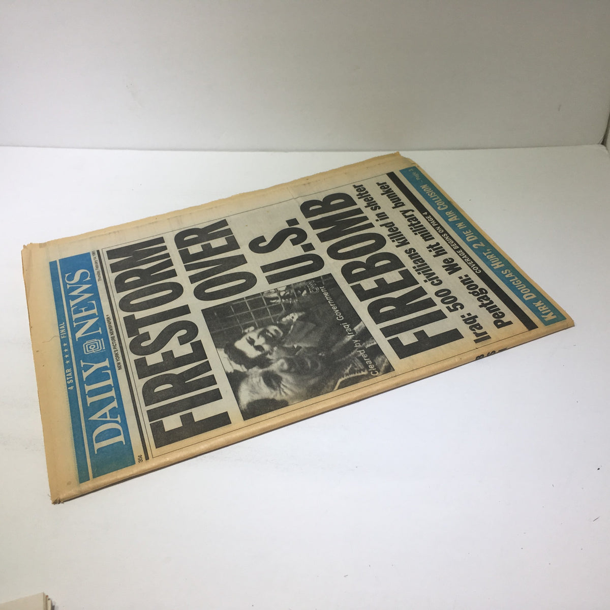 New York Daily News: Feb 14 1991, Firestorm Over U.S Firebomb, highlighting the headline with strong accusations about civilian casualties and the U.S military's bomb usage during the Gulf War.