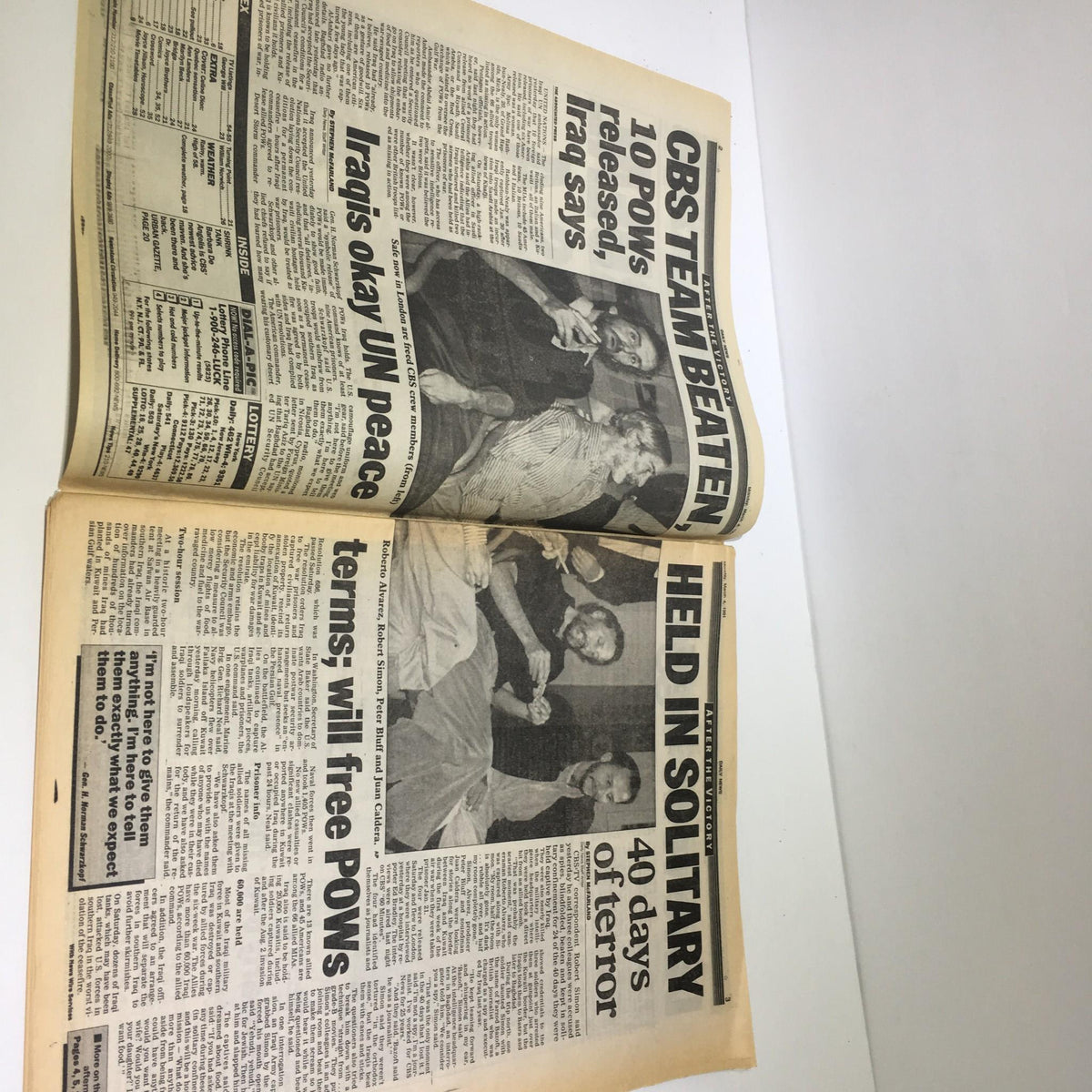 A vintage newspaper spread featuring the headline 'CBS Team Beaten: 10 POWs released,' alongside a report on an Iraqi decision to allow a peaceful resolution, dated March 4, 1991, titled 'War Ordeal of CBS 4 Iraq OKs Release of POWs.' The pages show minor wear, maintaining overall good condition.