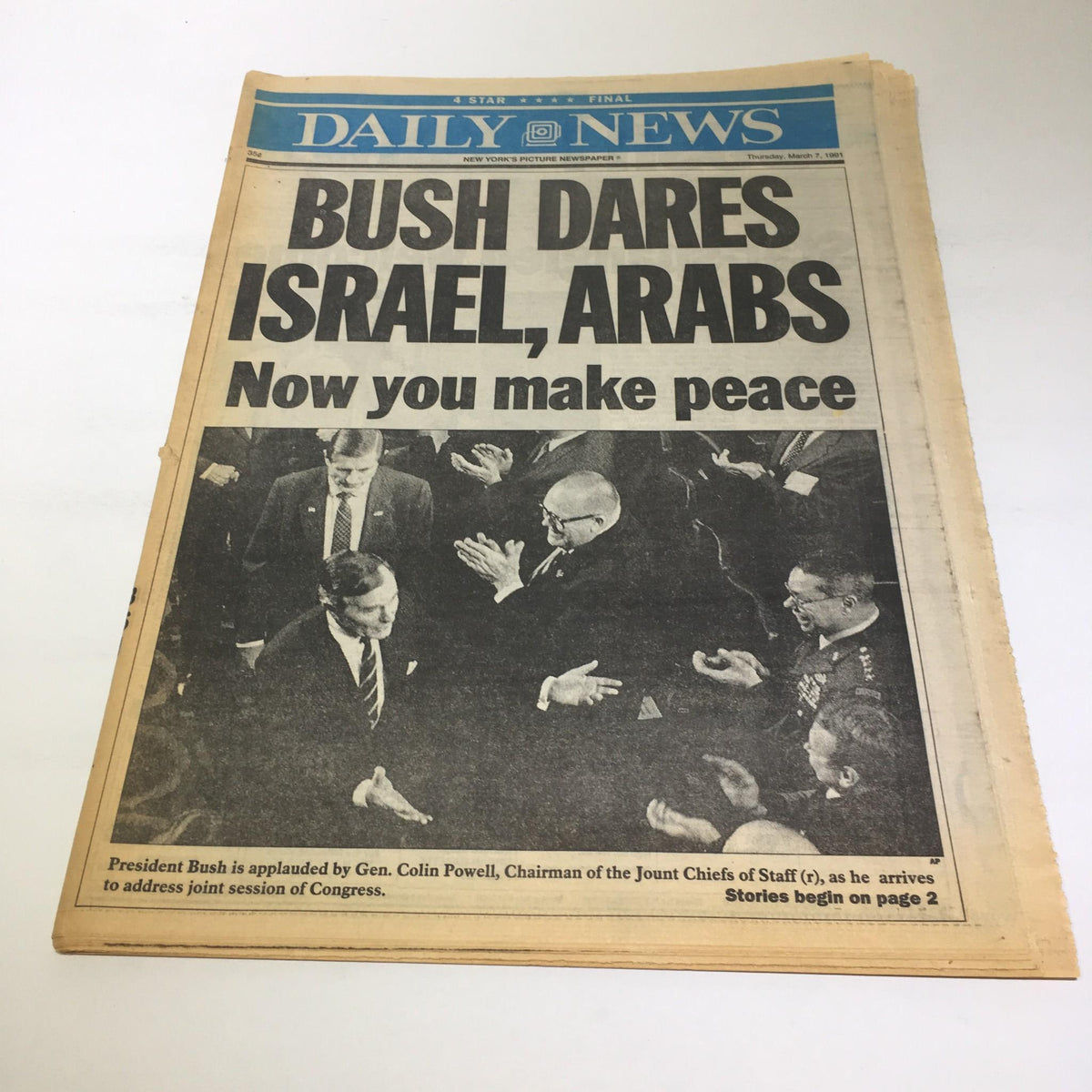 NY Daily News headline from March 7, 1991: 'Bush Dares Israel, Arabs Now you Make Peace.' Image depicts President Bush being applauded by dignitaries.