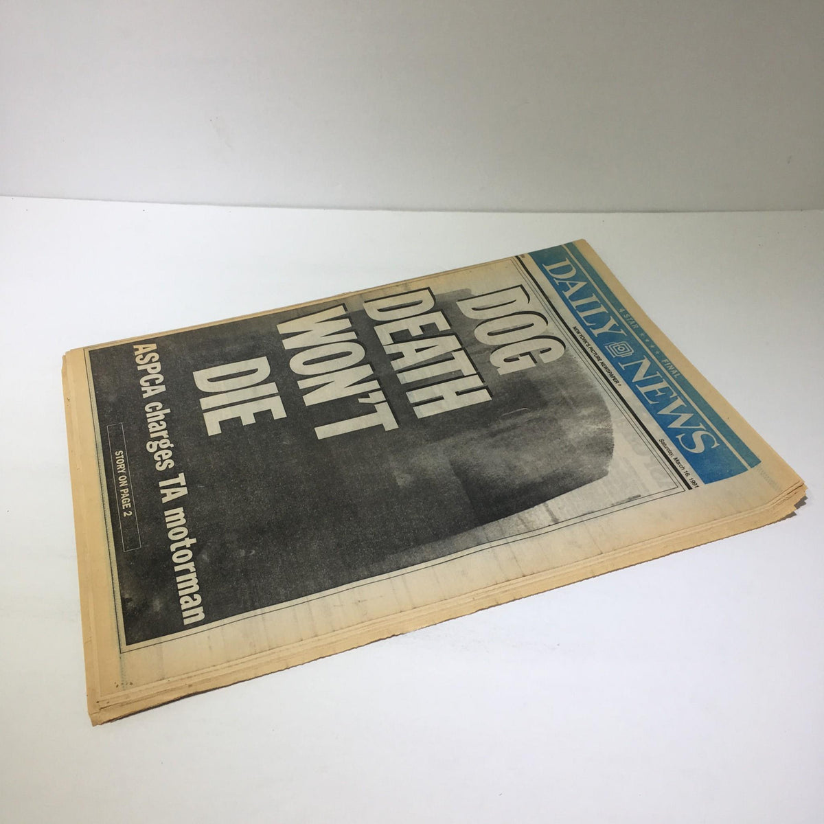 NY Daily News front cover featuring bold headline 'DOG DEATH WON'T DIE' from March 16, 1991, focusing on relevant legal charges regarding animal welfare.