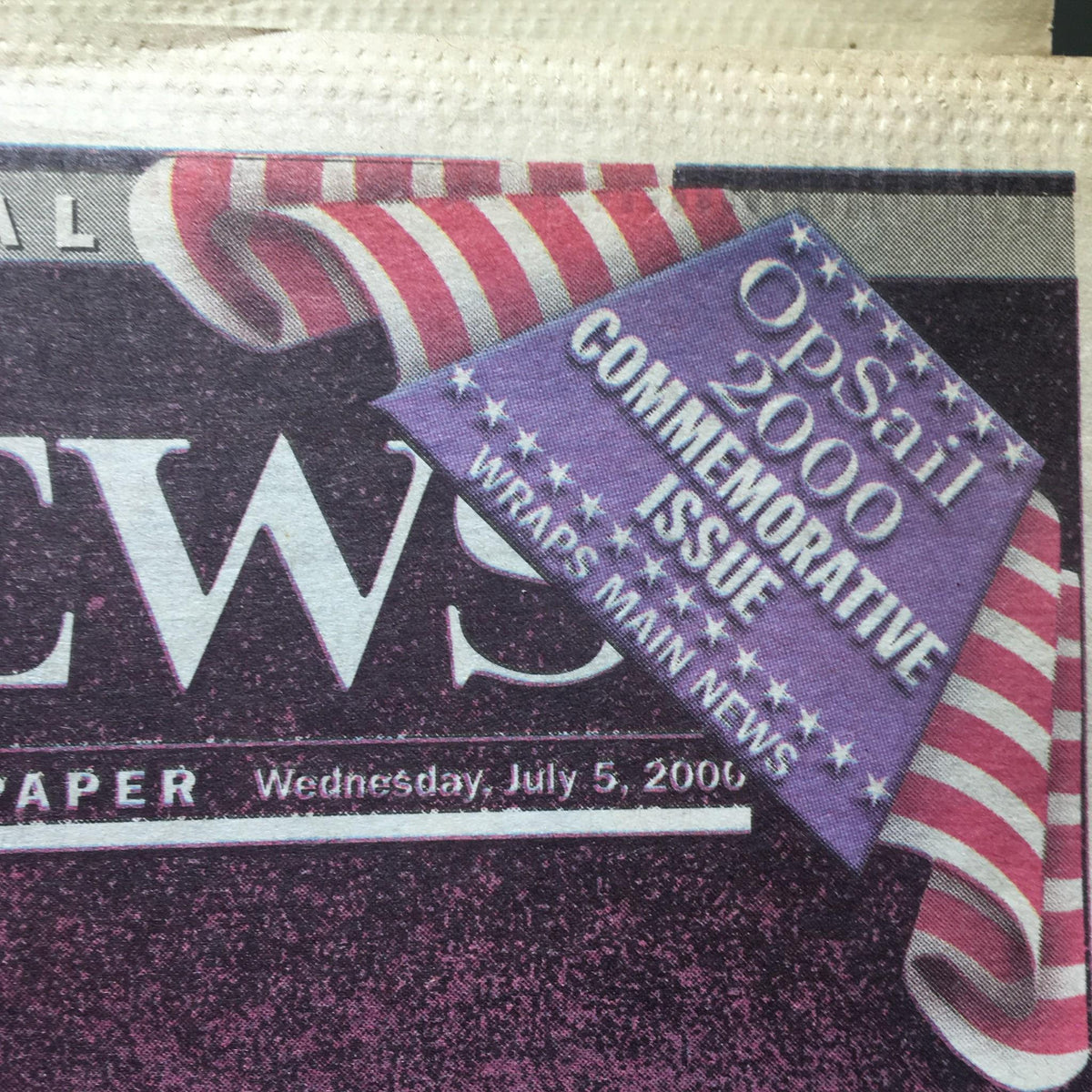 Detail of the commemorative issue label on the New York Daily News from July 5, 2000, featuring the OP Sail 2000 design.