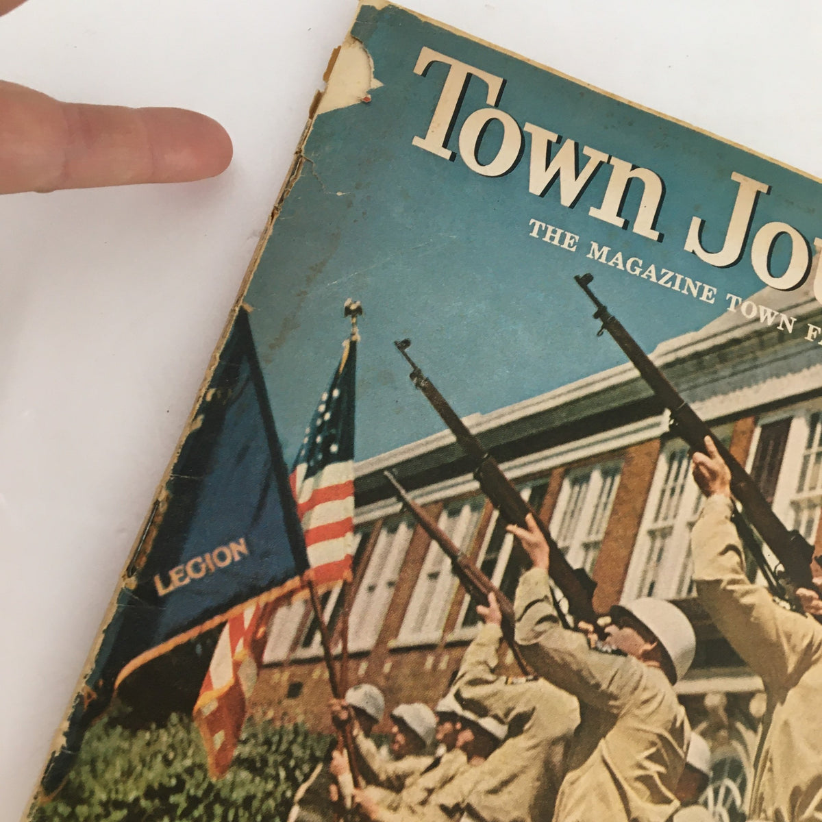 Close-up view of the cover of Town Journal Magazine May 1955 showing details of the Memorial Day parade and flag with 'LEGION' inscription.