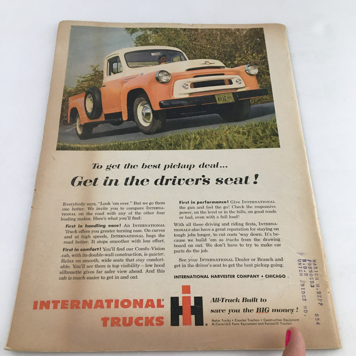 Back cover of Town Journal Magazine October 1956 showcasing an advertisement for International Trucks, featuring a colorful pickup truck and promoting its performance and handling features.