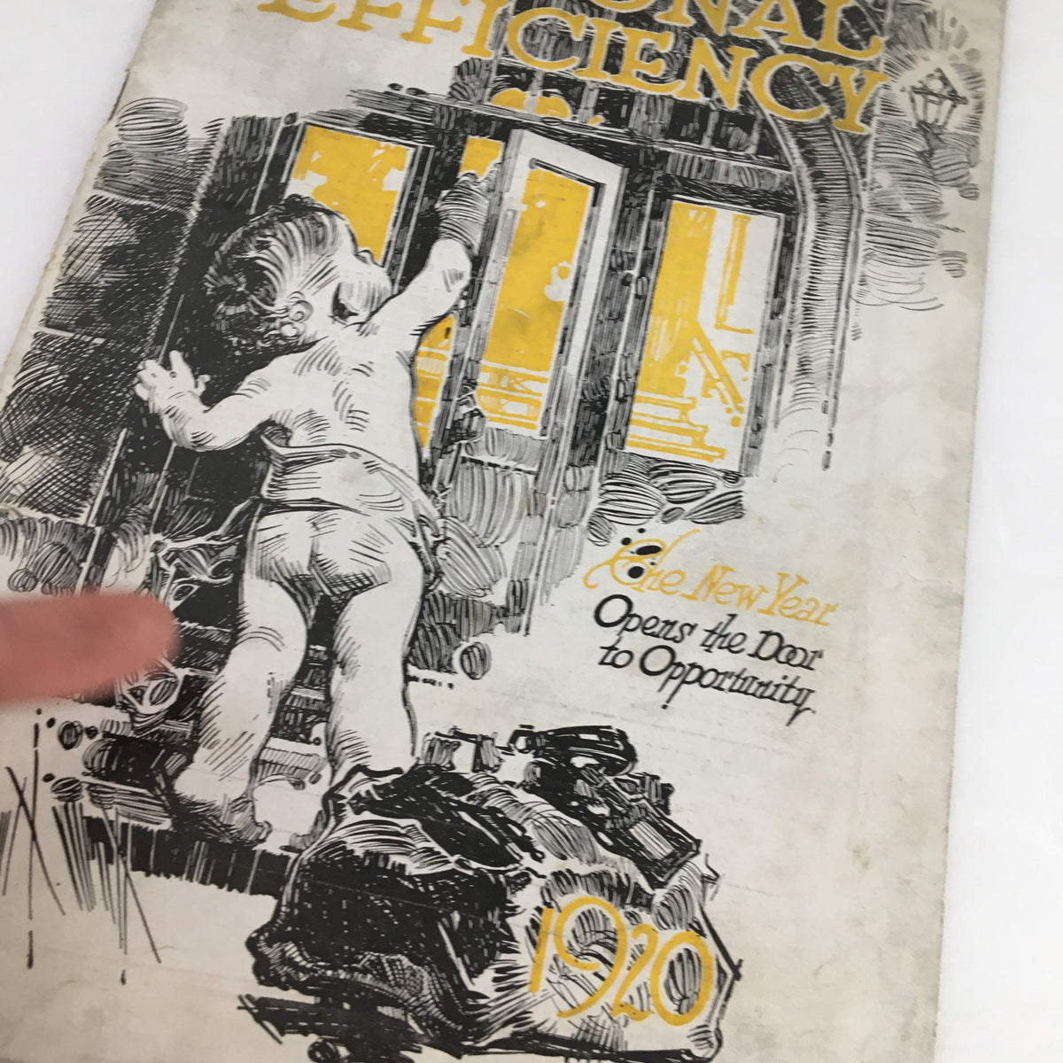 Close-up of the cover of Personal Efficiency Magazine January 1920 showing a child grasping a door handle with the caption 'The New Year Opens Door to Opportunity'.