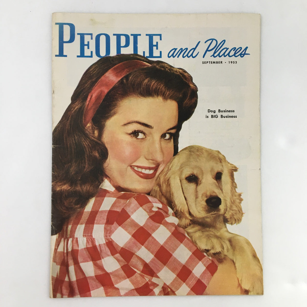 Cover of People and Places Magazine, September 1953, featuring a woman smiling while holding a golden retriever puppy, with the headline 'Dog Business is BIG Business'.