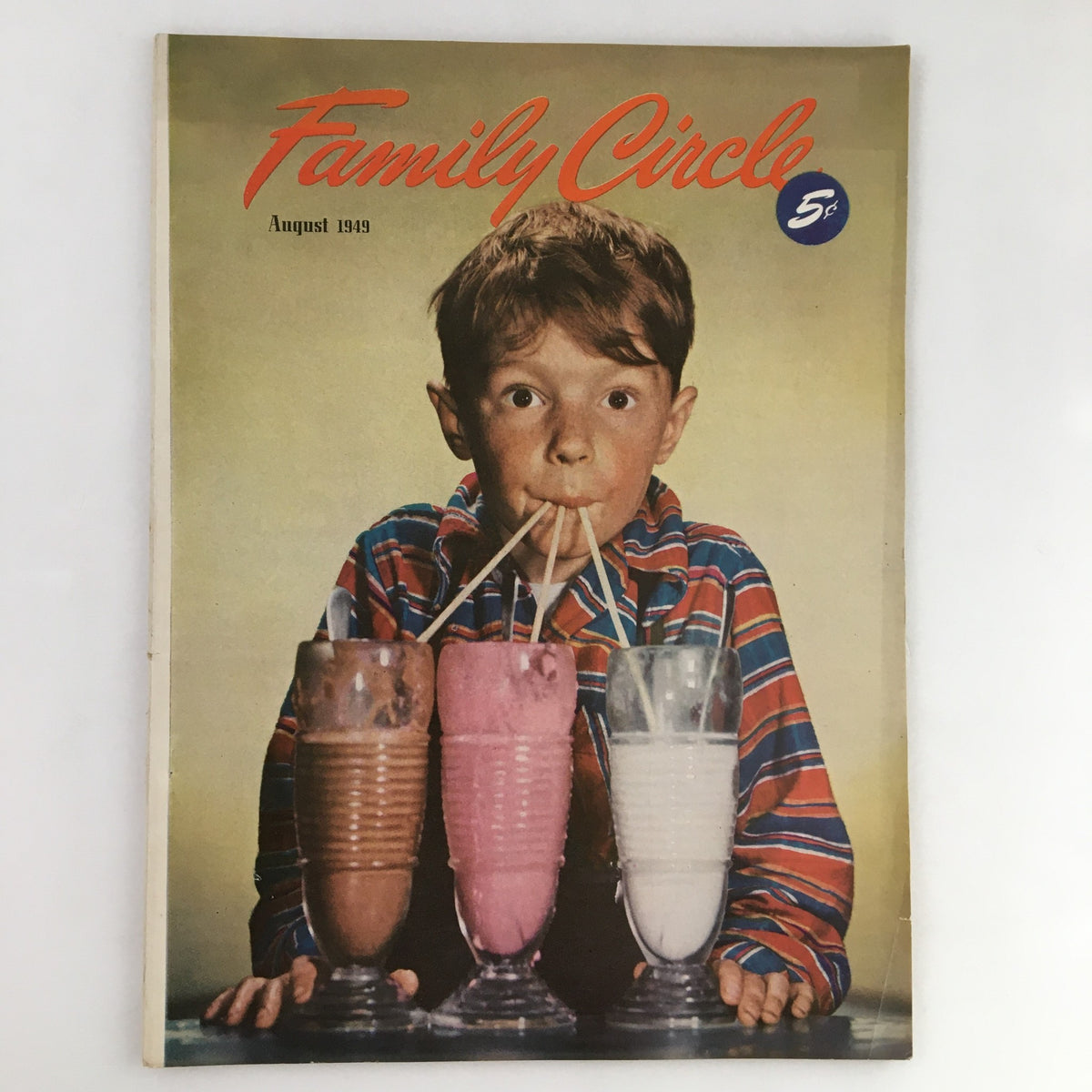 Family Circle Magazine August 1949 cover featuring a young boy drinking multiple milkshakes through straws, showcasing vintage Americana.