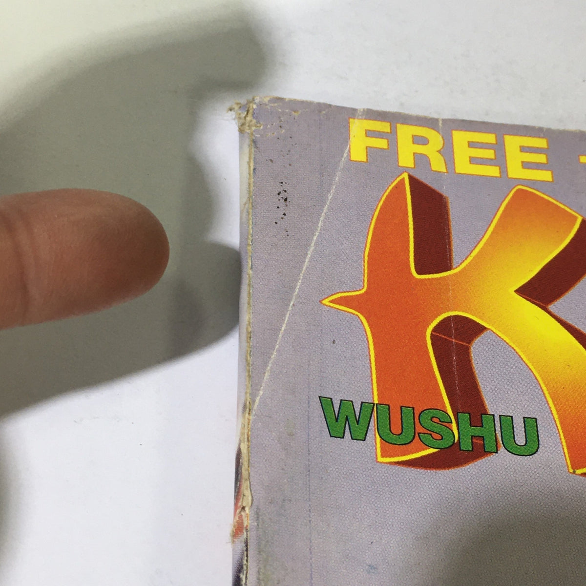 Close-up of the side edge of Wushu Qigong Kung Fu Magazine June July 1996 showcasing wear and details of the magazine's design.