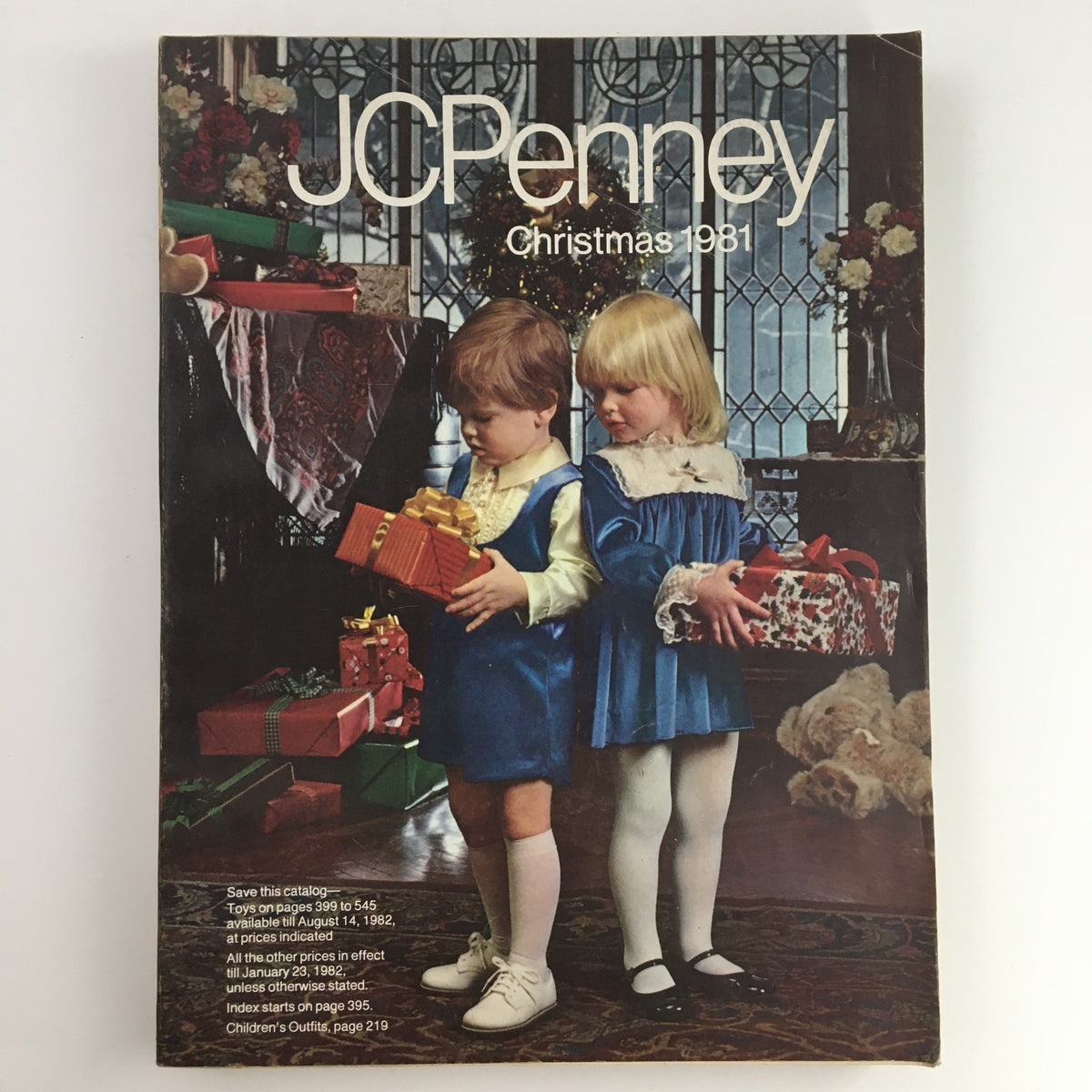 Cover of the 1981 JCPenney Dandy Christmas Children's Outfit Catalog featuring two children in festive outfits with holiday gifts.