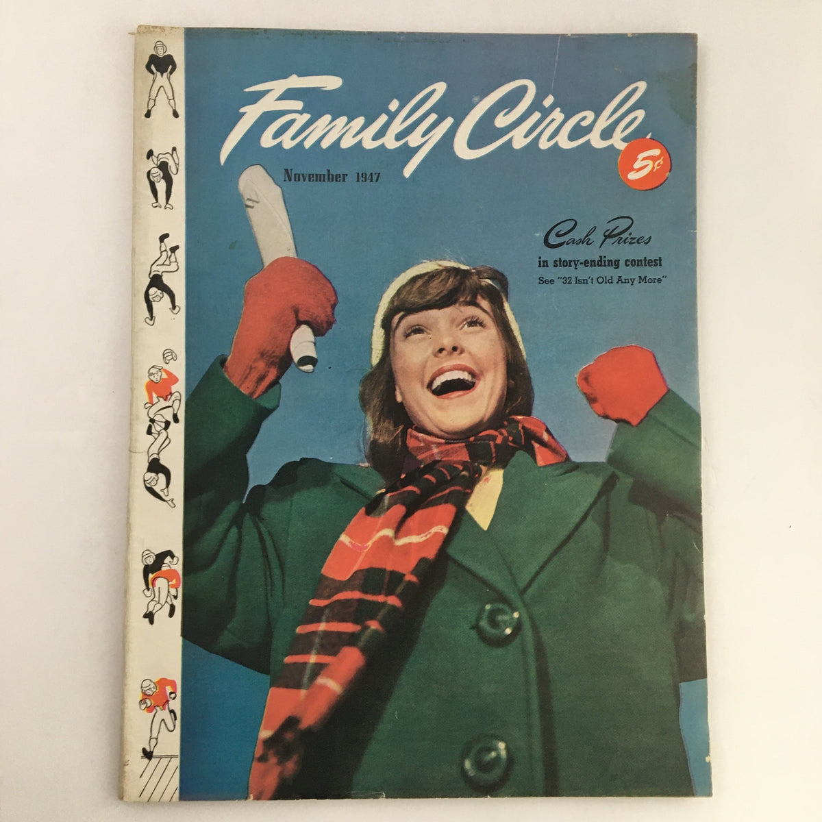 Cover of Family Circle Magazine November 1947 featuring a joyful woman in a green coat and red scarf, holding a microphone, promoting the Cash Prize Story-Ending Contest.