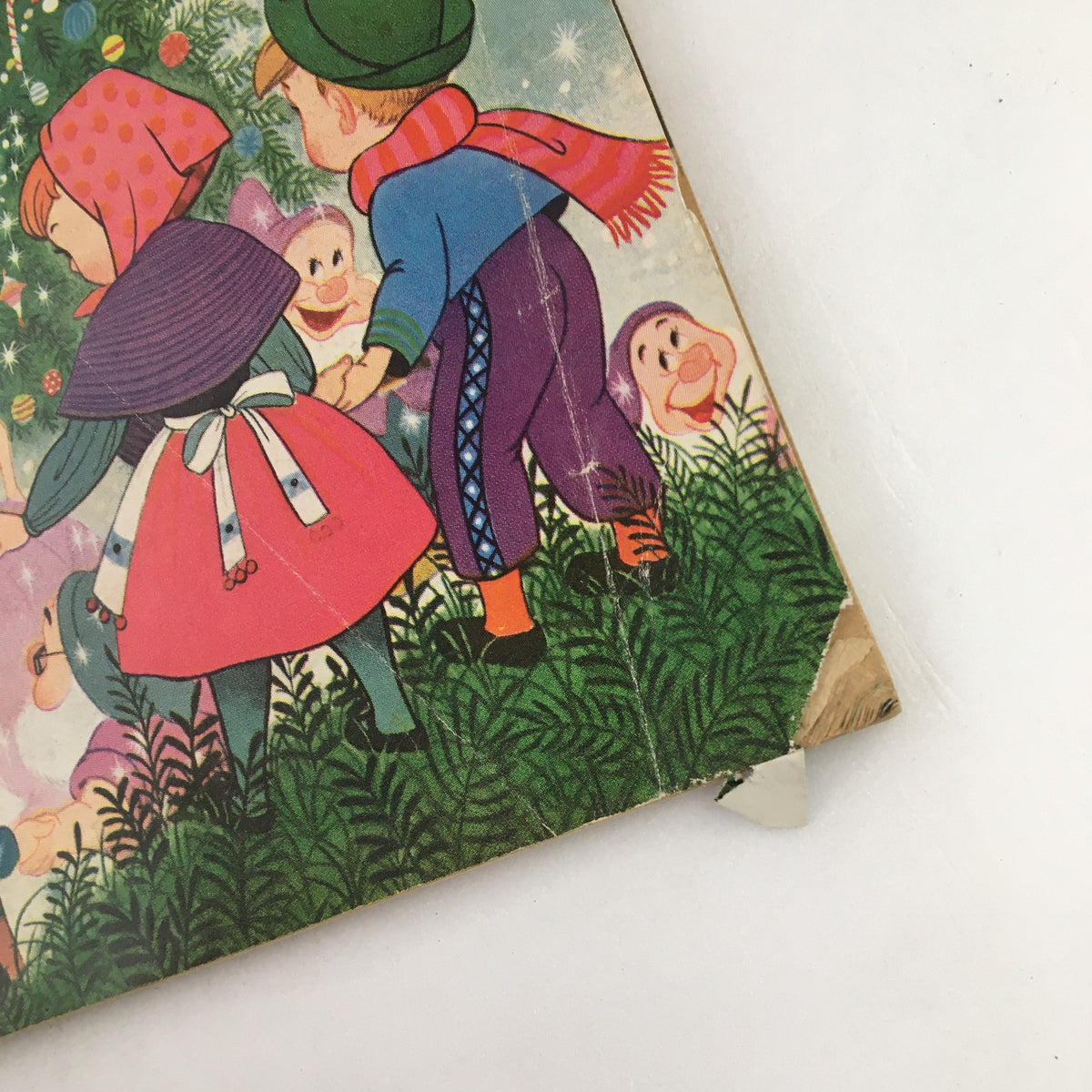 Detail of the Family Circle Magazine December 1958 showing characters celebrating Christmas in colorful attire, with whimsical backgrounds and nostalgic illustrations.
