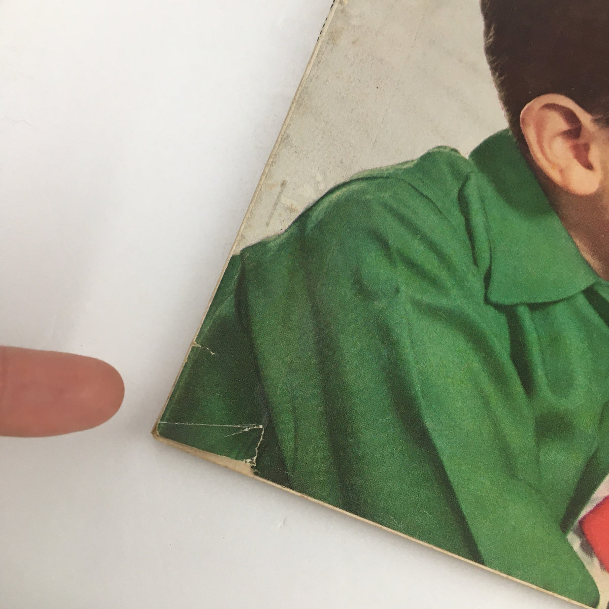 Close-up of the corner of Family Circle Magazine December 1955, showing wear and tear on the cover, capturing its vintage charm.