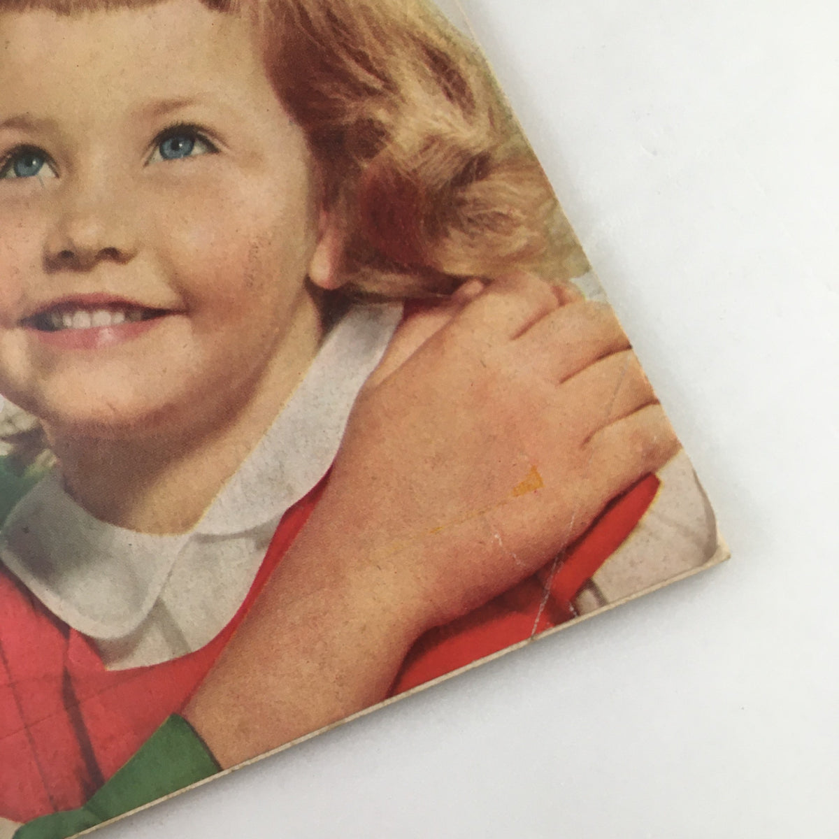 Detailed view of the girl on the cover of Family Circle Magazine December 1955, with a joyful expression, emphasizing the festive theme of the issue.