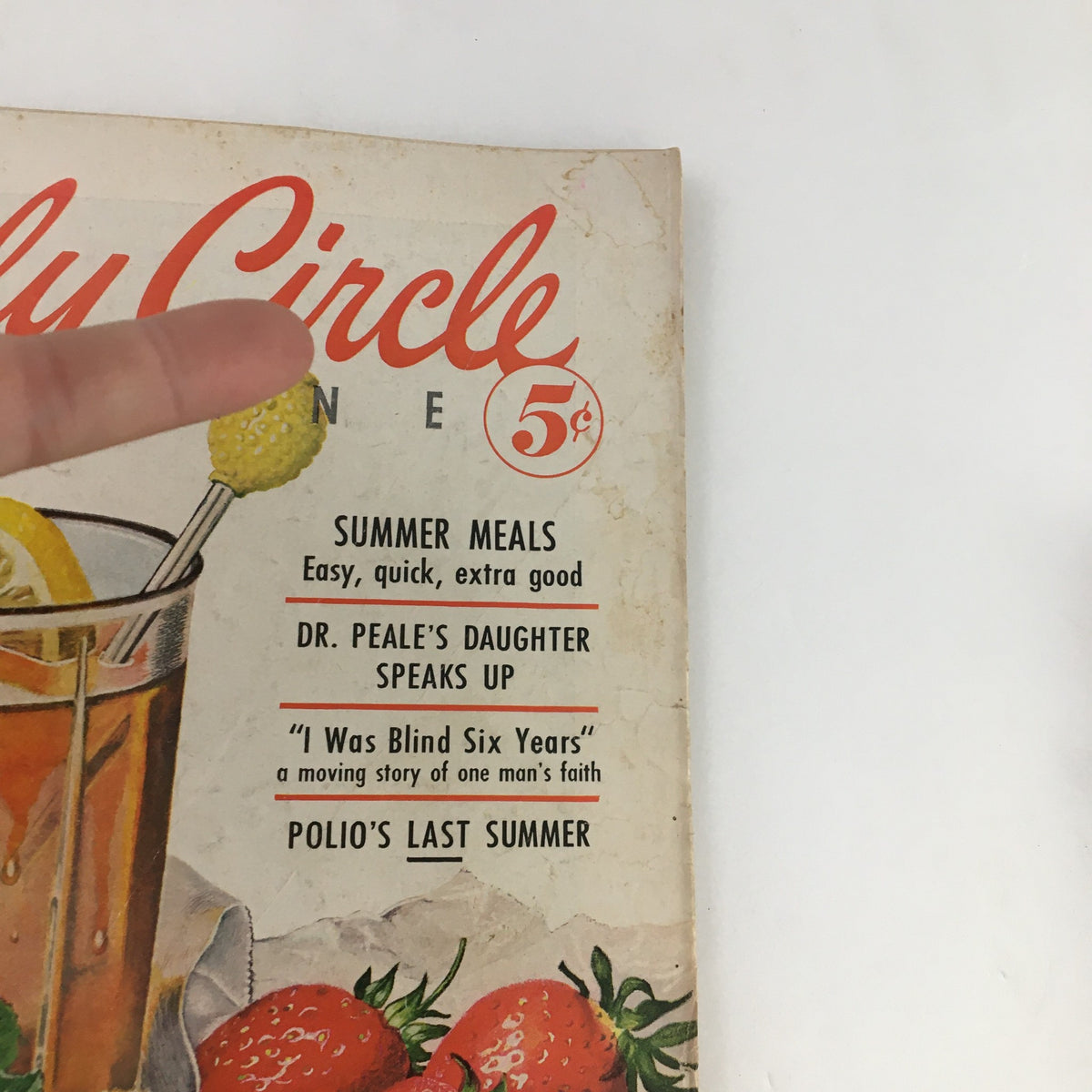 Close-up of the cover of Family Circle Magazine June 1955 highlighting the title and key articles, including 'Dr. Peale's Daughter Speaks Up' and 'Summer Meals.' A vintage artifact showcasing 1950s family life.