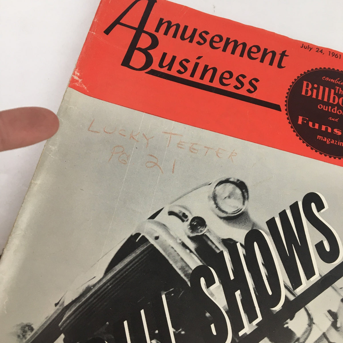 Close-up of Amusement Business Magazine July 24, 1961 cover with handwritten note 'Lucky Teeter Pg 21' highlighting its vintage character and authenticity.