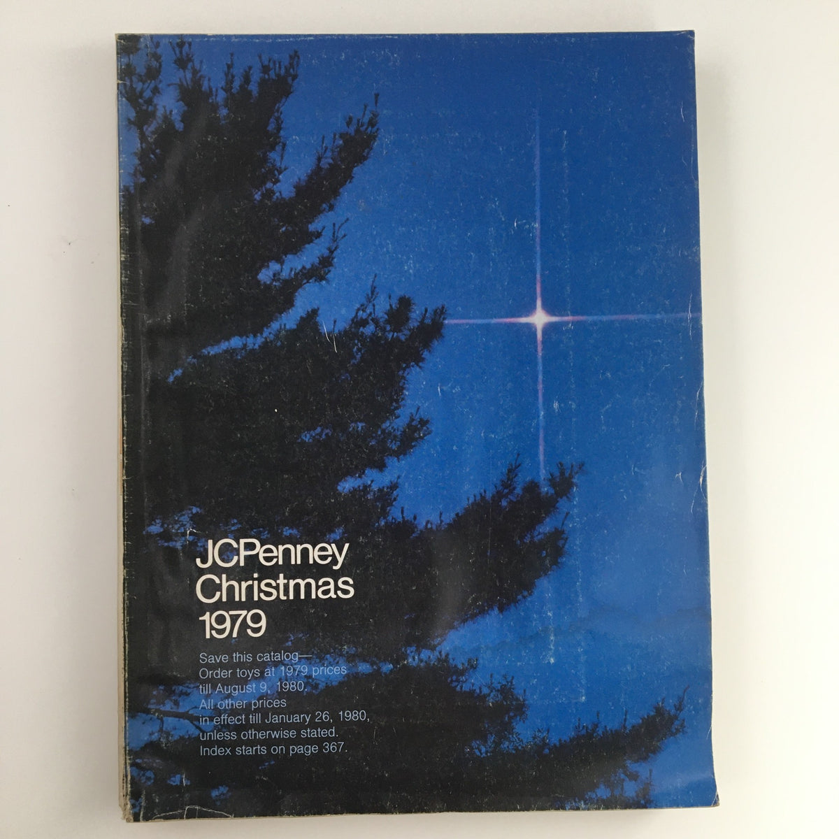 Cover of the 1979 JCPenney Christmas Toys Prices Catalog featuring a starry night with trees, highlighting the catalog's vintage charm.