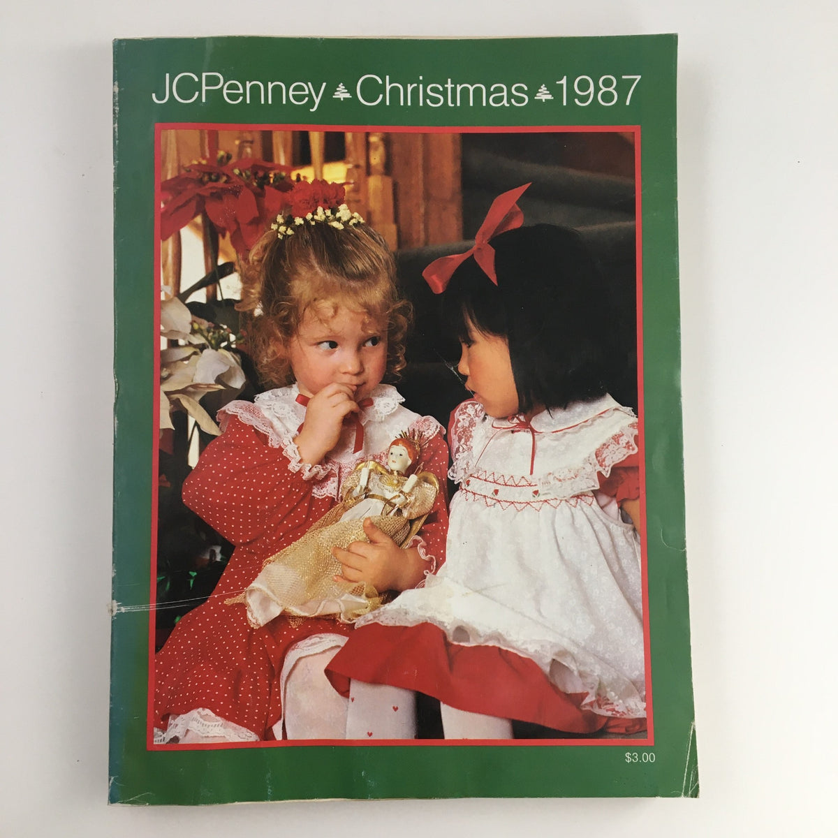 Cover of the 1987 JCPenney Christmas Party at Grandma's House Catalog featuring two girls in festive dresses Amid Christmas decorations.