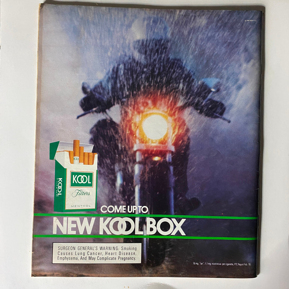 Back cover of VTG Spin Magazine December 1985 Vol 1 No. 8 featuring an advertisement for Kool Filters menthol cigarettes with a dramatic image of a motorcyclist in the rain.