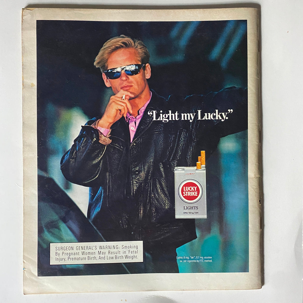 Back cover of the February 1986 Spin Magazine featuring a Lucky Strike advertisement, displaying a stylish model in sunglasses promoting smoking culture.