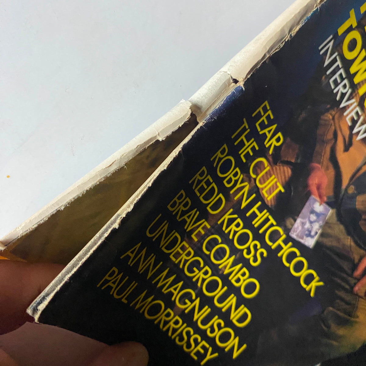 Detail of the spine of VTG Spin Magazine March 1986 Vol 1 No. 11, highlighting wear and vintage aesthetic.