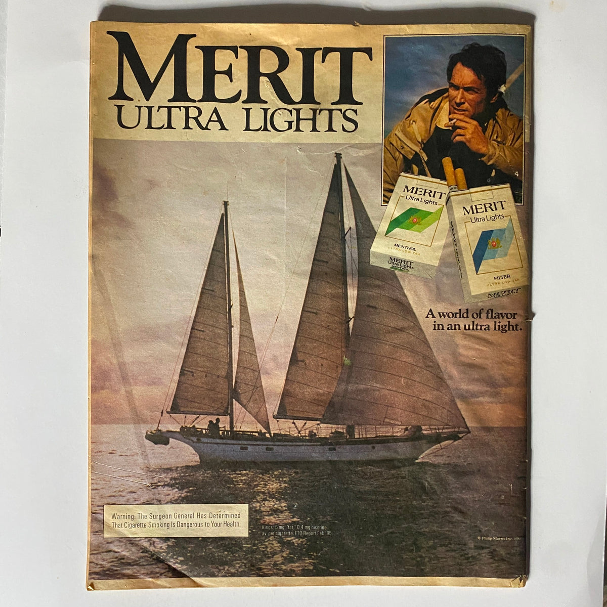 Merit Ultra Lights advertisement featured in Star Tabloid Magazine from May 28, 1985 showcasing a serene sailing scene paired with branding for ultra-light cigarettes.