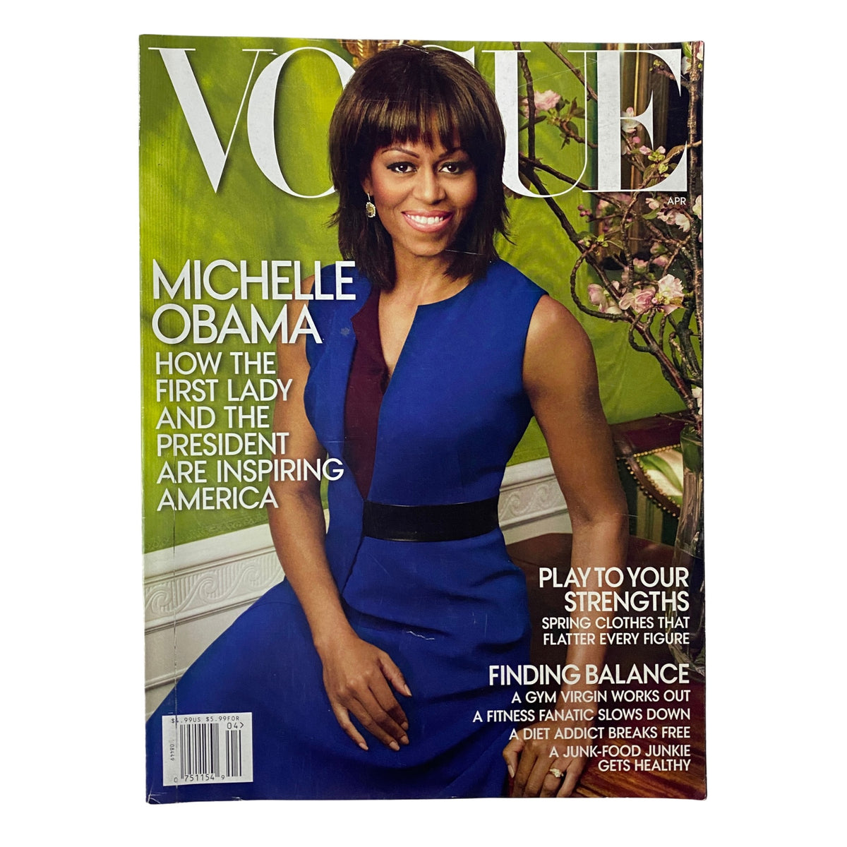 Cover of Vogue Magazine April 2013 featuring Michelle Obama, showcasing her in a stylish blue dress. The title, 'Vogue', is prominently displayed with text highlighting how the First Lady and the President are inspiring America.