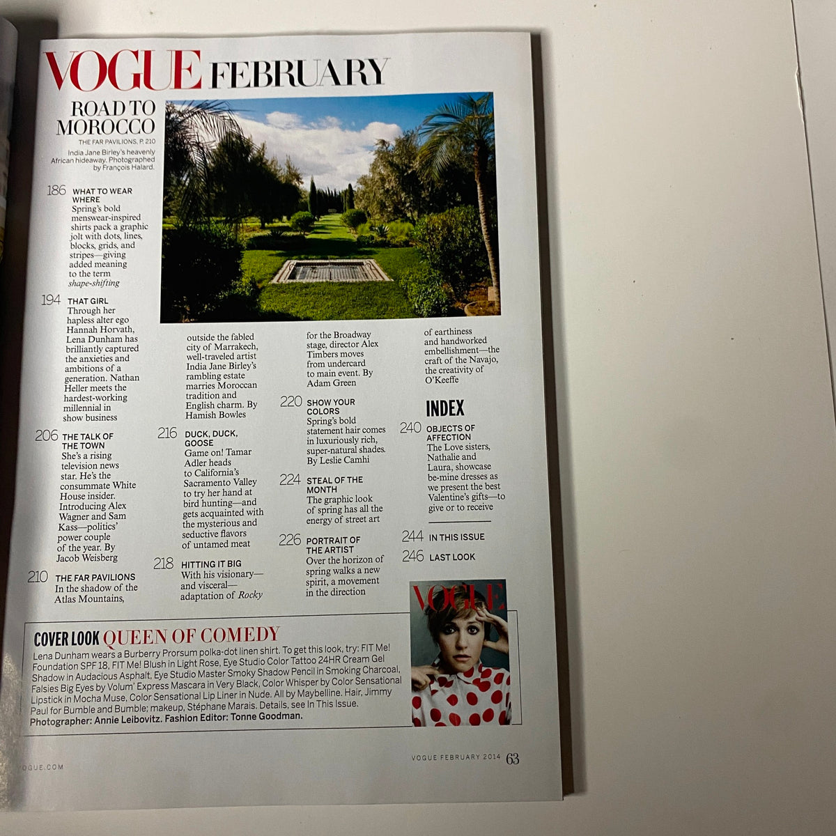 Vogue Magazine February 2014 features an article titled 'Road to Morocco' showcasing a lush garden landscape. This page includes high-fashion content related to travel and style.