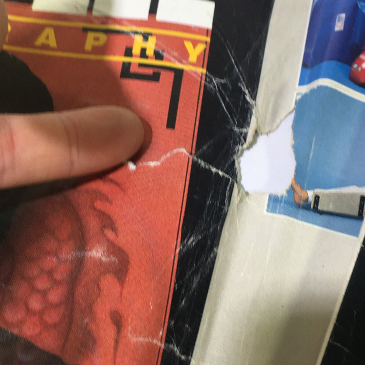 Close-up view of the cover of 'Inside Fung Fu Presents Martial Artists March 1990 - Conan Lee / Chuck Norris', showing visible wear and tear, including creases and a tear, ideal for collectors.