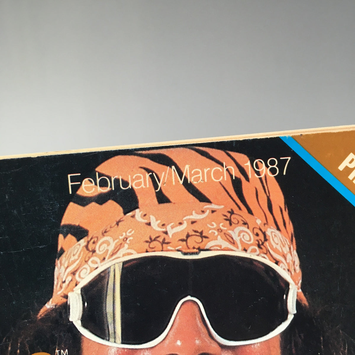 Close-up of the WWF Magazine cover showcasing Randy Savage's signature bandana and sunglasses, from the February/March 1987 issue titled 'Randy Savage Still Holds the Belt'.
