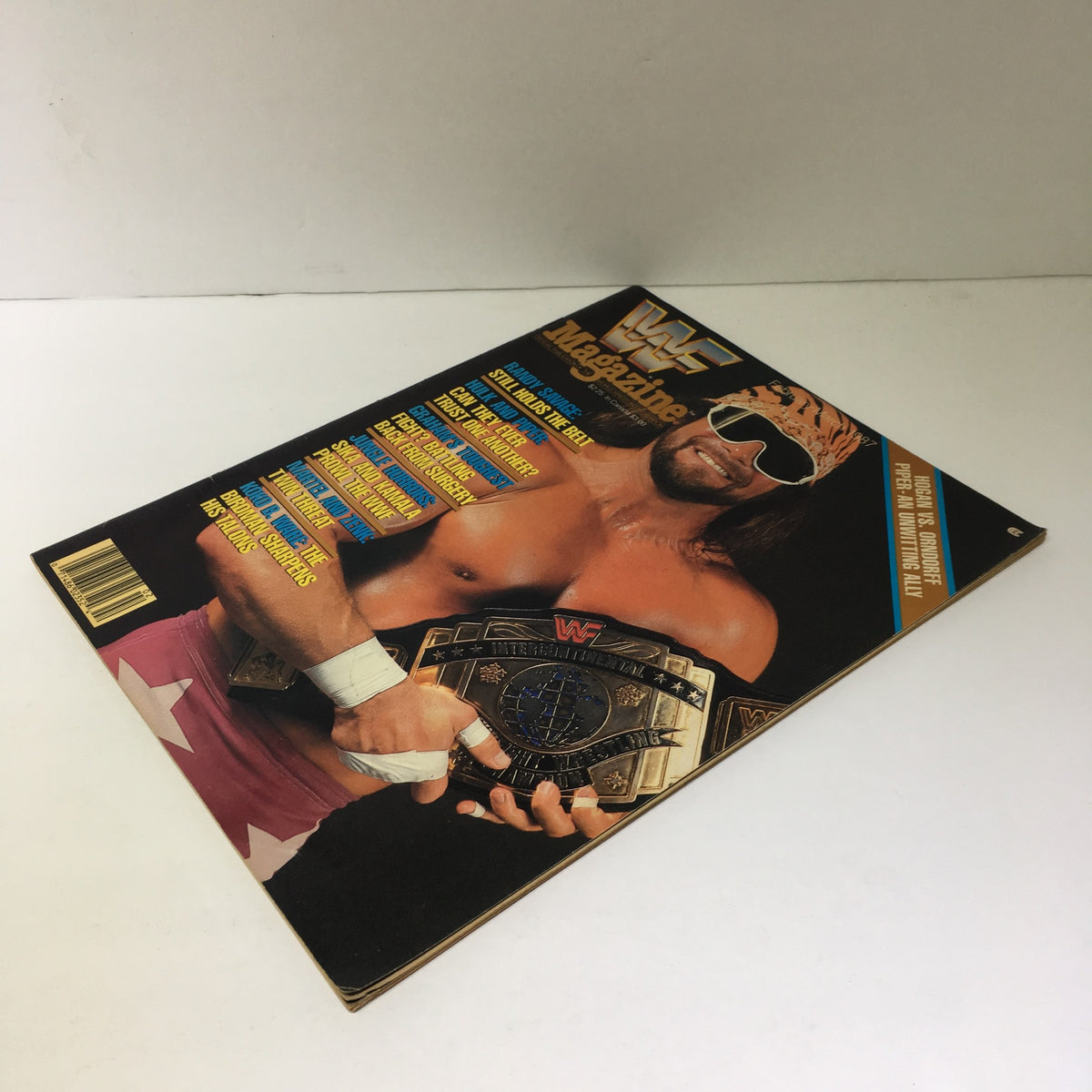 WWF Magazine featuring Randy Savage Still Holds the Belt, February/March 1987, showcasing Randy Savage with the championship belt, excellent condition, minimal wear.