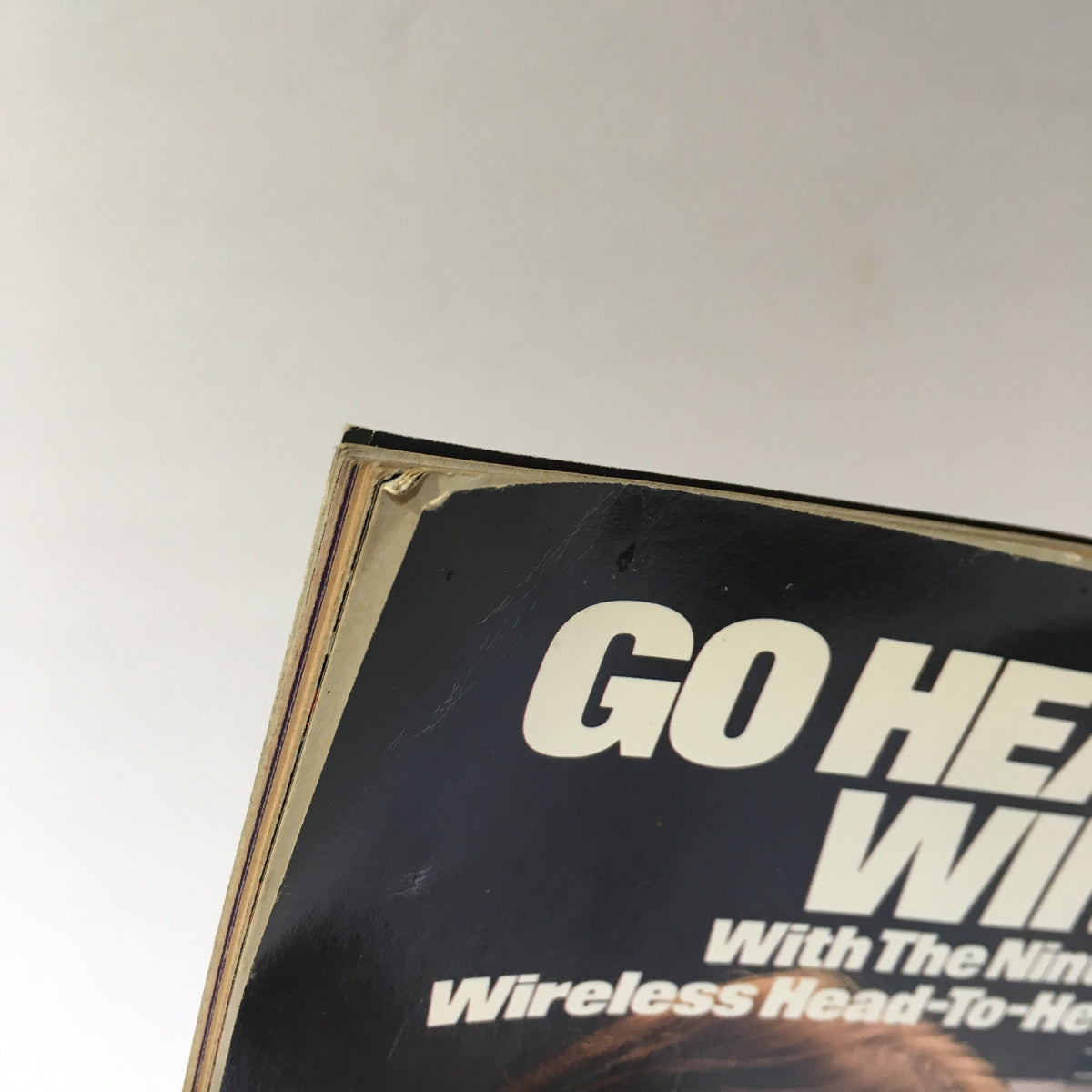 Top edge of WWF Magazine showing the title 'Go Head-To-Head, Wireless!' from a Nintendo advertisement, highlighting its vintage appeal.