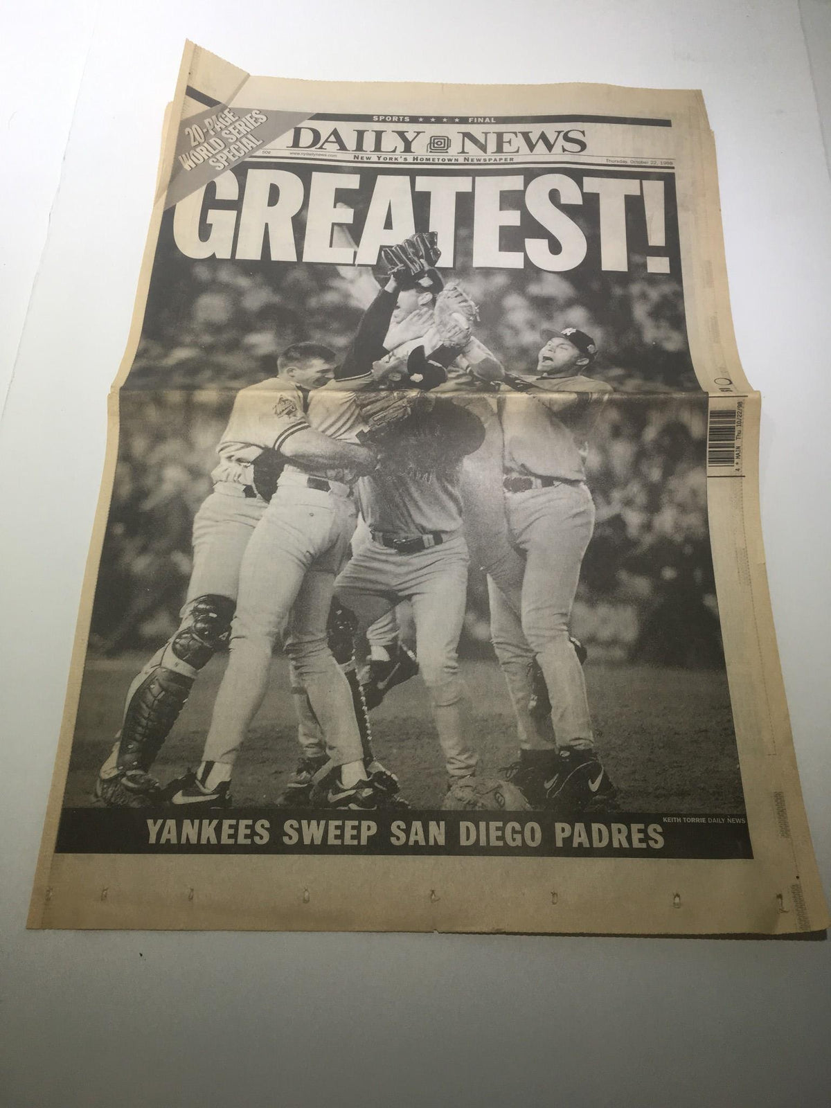 New York Daily News headline 'GREATEST!' featuring the October 22, 1998 issue documenting the New York Yankees sweeping the San Diego Padres in the World Series. The image showcases players celebrating the historic victory, capturing a pivotal moment in baseball history.