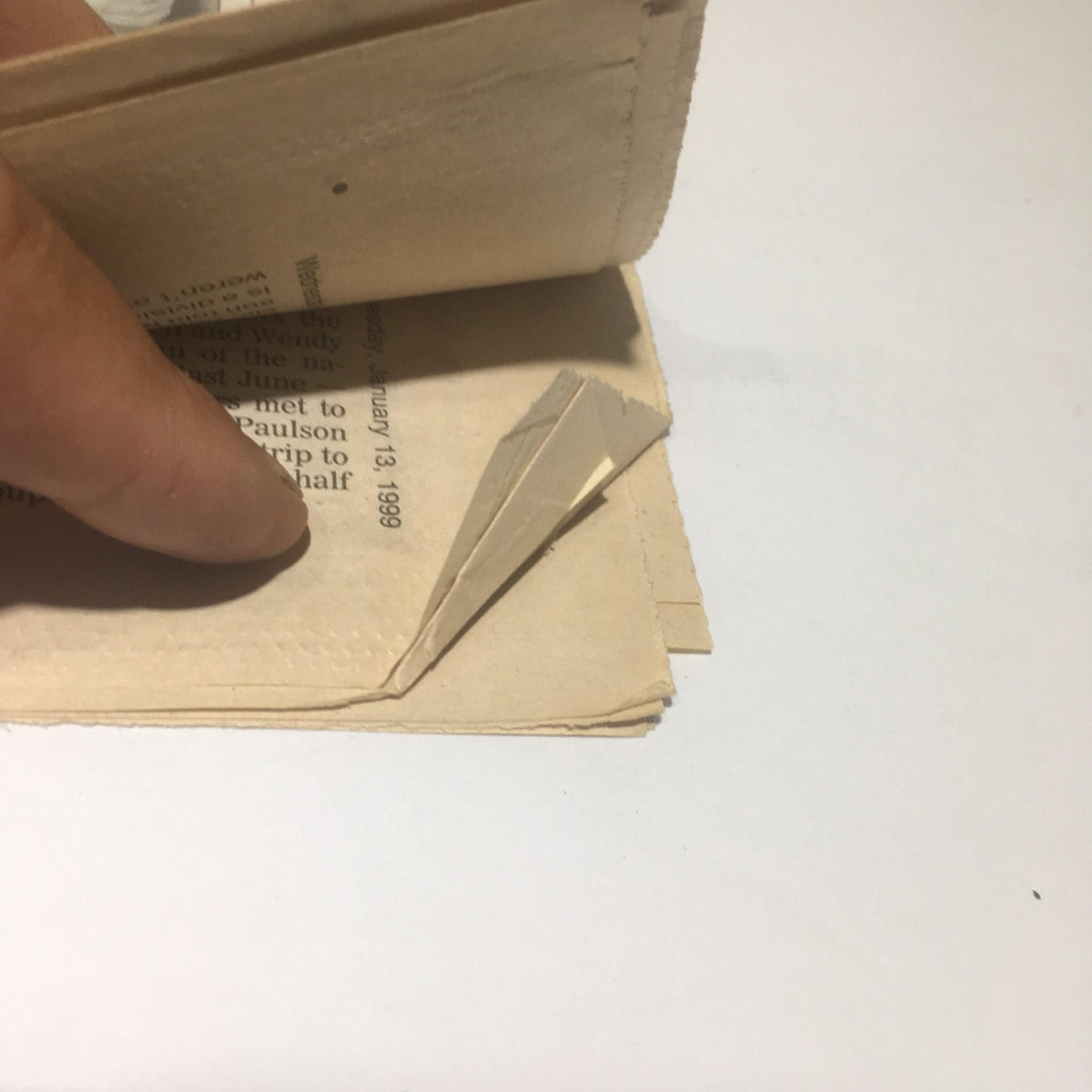 Detail shot of the NY Daily News newspaper, highlighting a folded page showing the sale of McGwire's 70th home run ball for $2.7M.