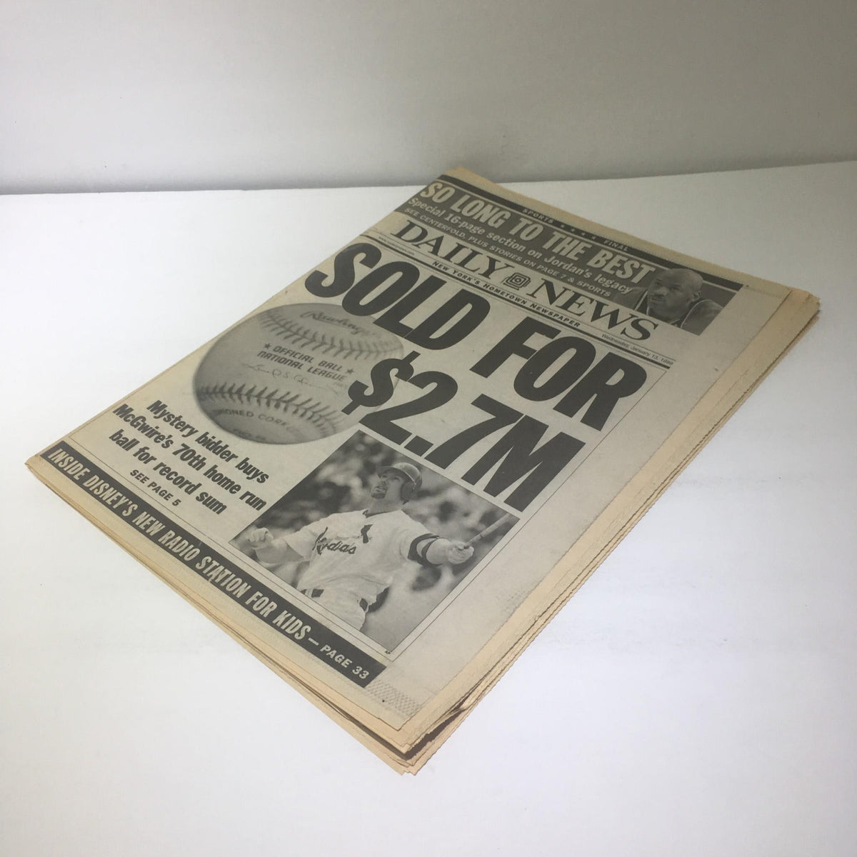 NY Daily News showcasing the article 'SOLD FOR $2.7M' detailing the sale of McGwire's 70th home run ball, highlighting the historic event in baseball memorabilia.