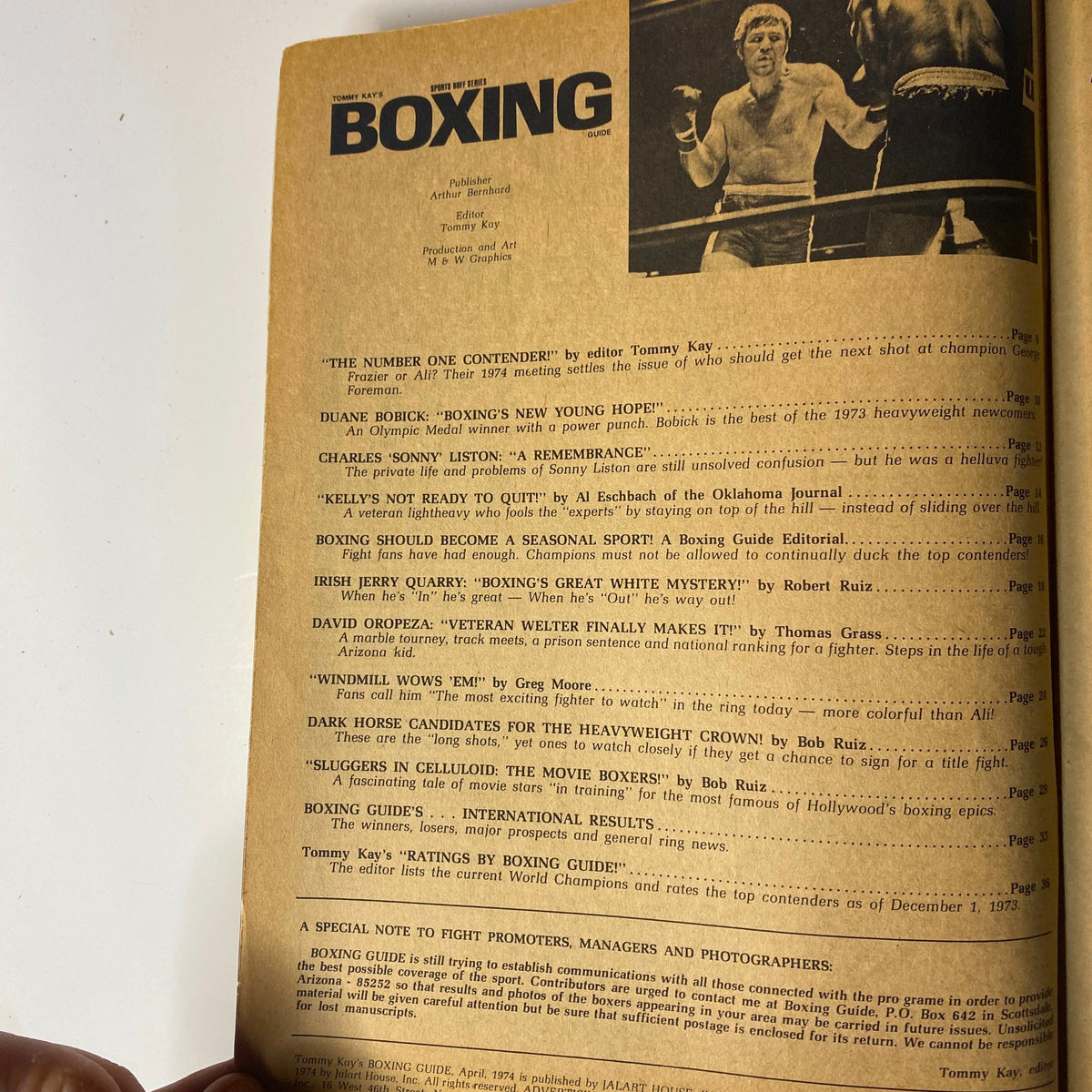 Page from Tommy Kay's Boxing Magazine April 1974 featuring article titles such as 'The Number One Contender!' and 'Duane Bobick: Boxing’s New Young Hope', showcasing insights into notable boxers and fight commentary.