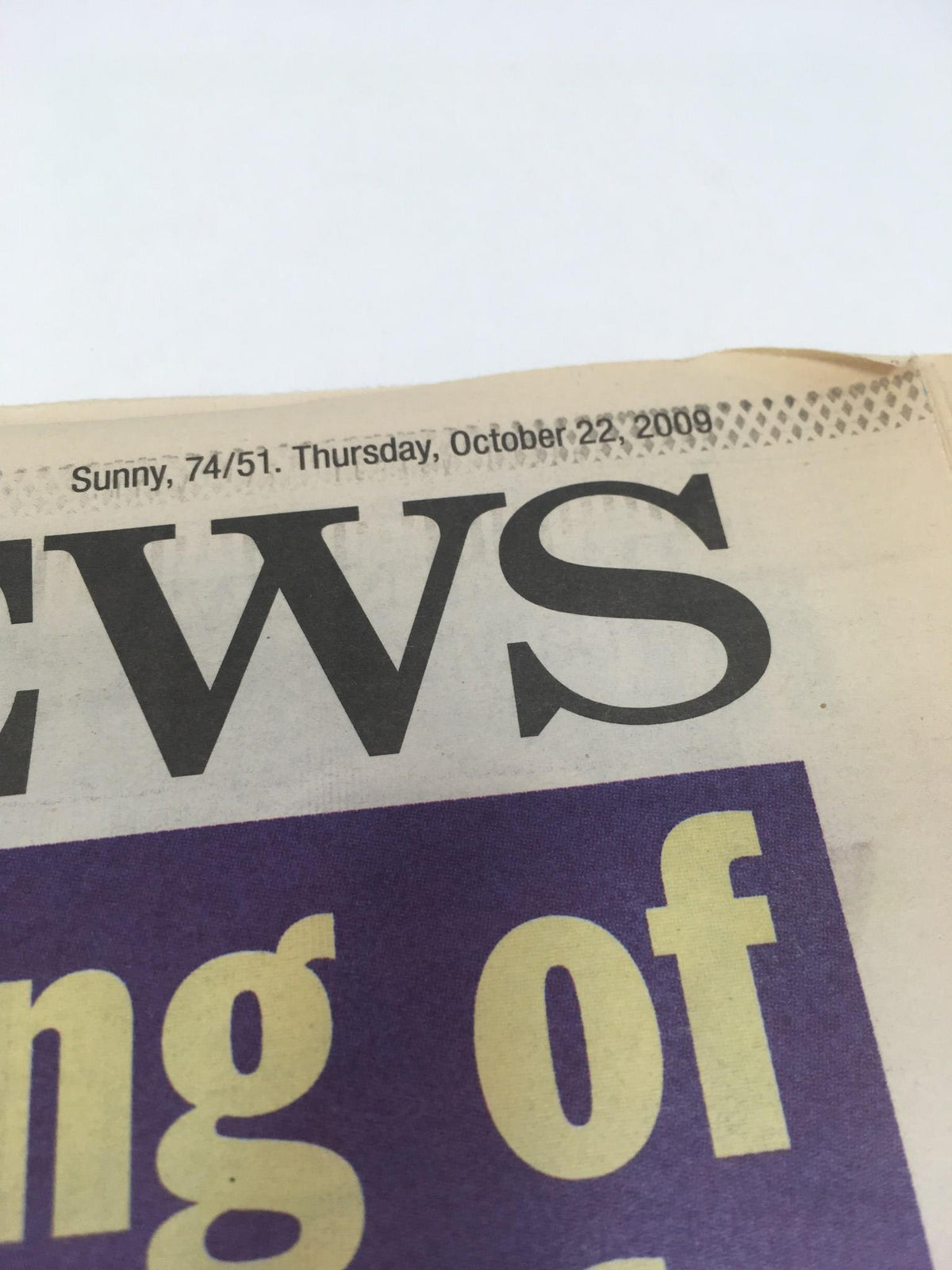 Top corner of the NY Daily News front page dated Thursday, October 22, 2009, showing weather details, enhances the context of the newspaper's publication.