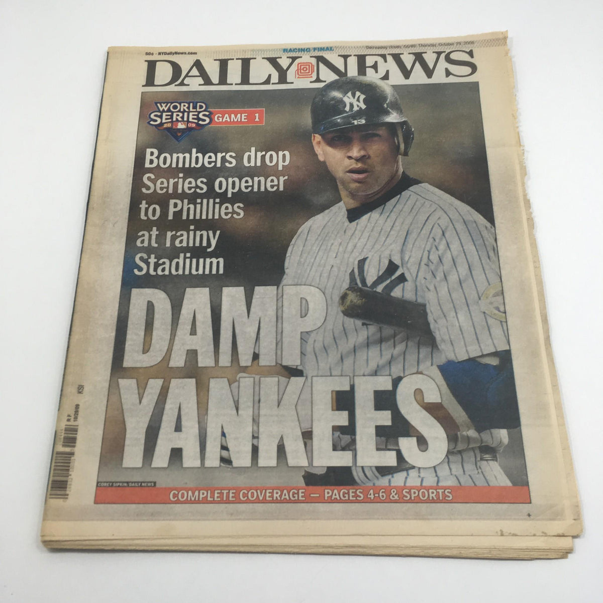 Front cover of the NY Daily News titled 'Damp Yankees' from October 29, 2009, featuring a Yankees player with a headline about the World Series opener against the Phillies in rainy conditions.