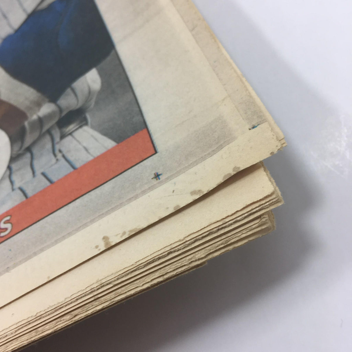 Close-up of the edge of the NY Daily News magazine titled 'Damp Yankees,' highlighting minor wear typical of its age, indicating its collectible status.
