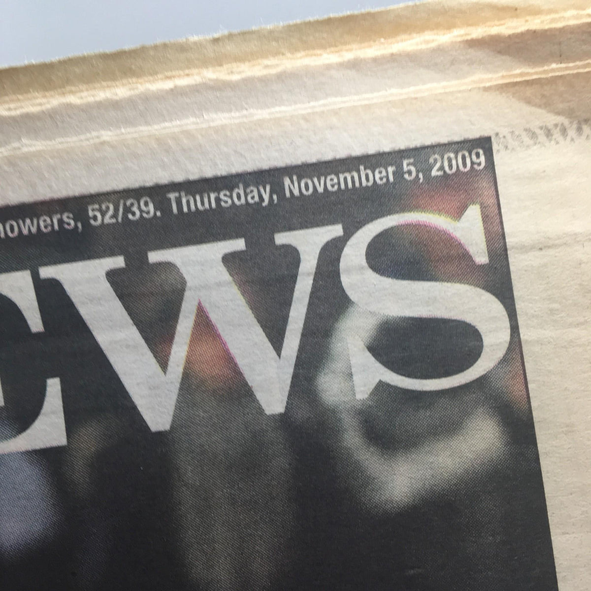 Close-up of the date on New York Daily News, November 5, 2009 issue, detailing the publication date and featuring a faint image.