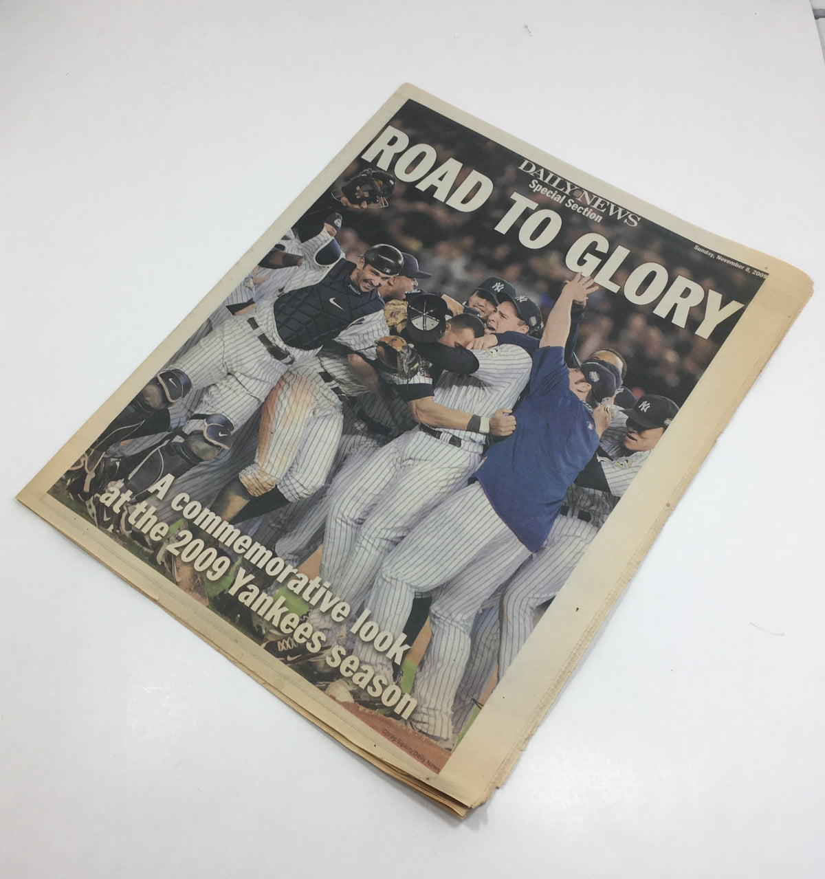 Cover image of the NY Daily News titled 'Road to Glory: A Commemorative Look at the 2009 Yanks Season', depicting Yankees players celebrating a significant victory.