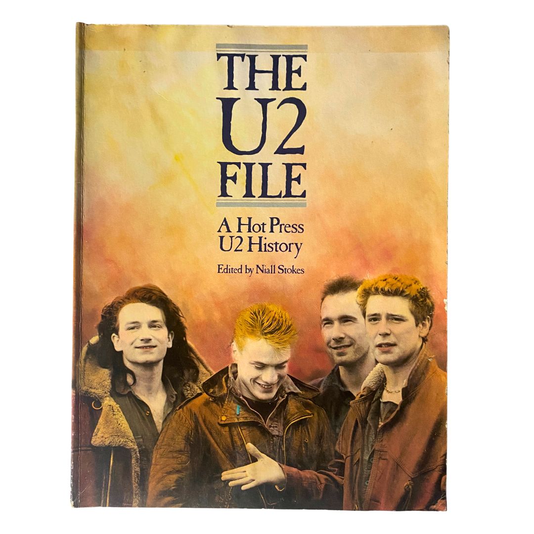 The U2 File: A Hot Press U2 History featuring the band U2, edited by Niall Stokes, with four band members posing for the cover photo.