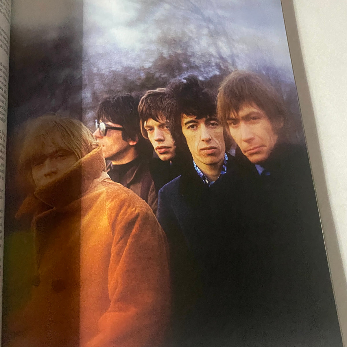A vintage photograph of The Rolling Stones band members captured in a moody setting, featured in the September 2013 issue of Rolling Stone Magazine.