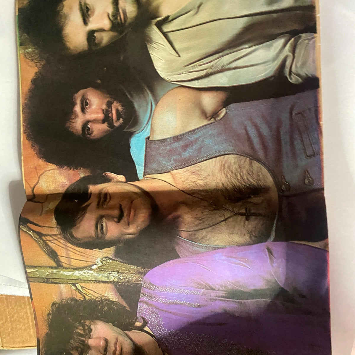 Centerfold from Hit Parader magazine July 1976 featuring a colorful photo of four musicians, showcasing the iconic fashion and style of the rock scene during this era.