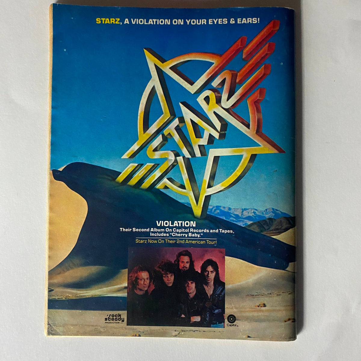 Cover of the Vintage Rock Scene Magazine July 1977 featuring the title 'STARZ, A Violation on Your Eyes & Ears!' promoting the band Starz and their music.