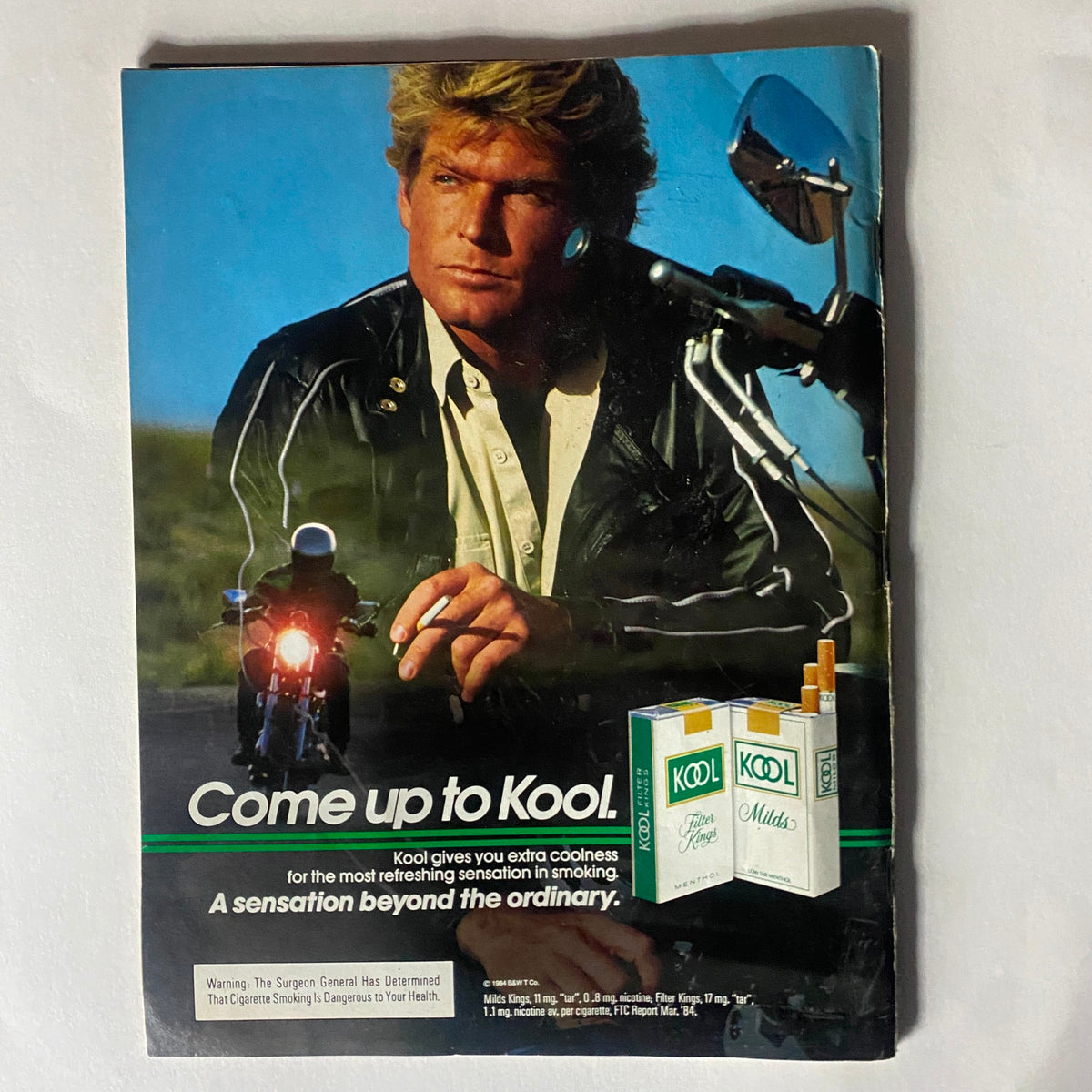 Advertisement from VTG Record Magazine November 1984 Vol 4 No. 1 featuring a model promoting Kool cigarettes, showcasing vintage advertising styles of the 1980s.