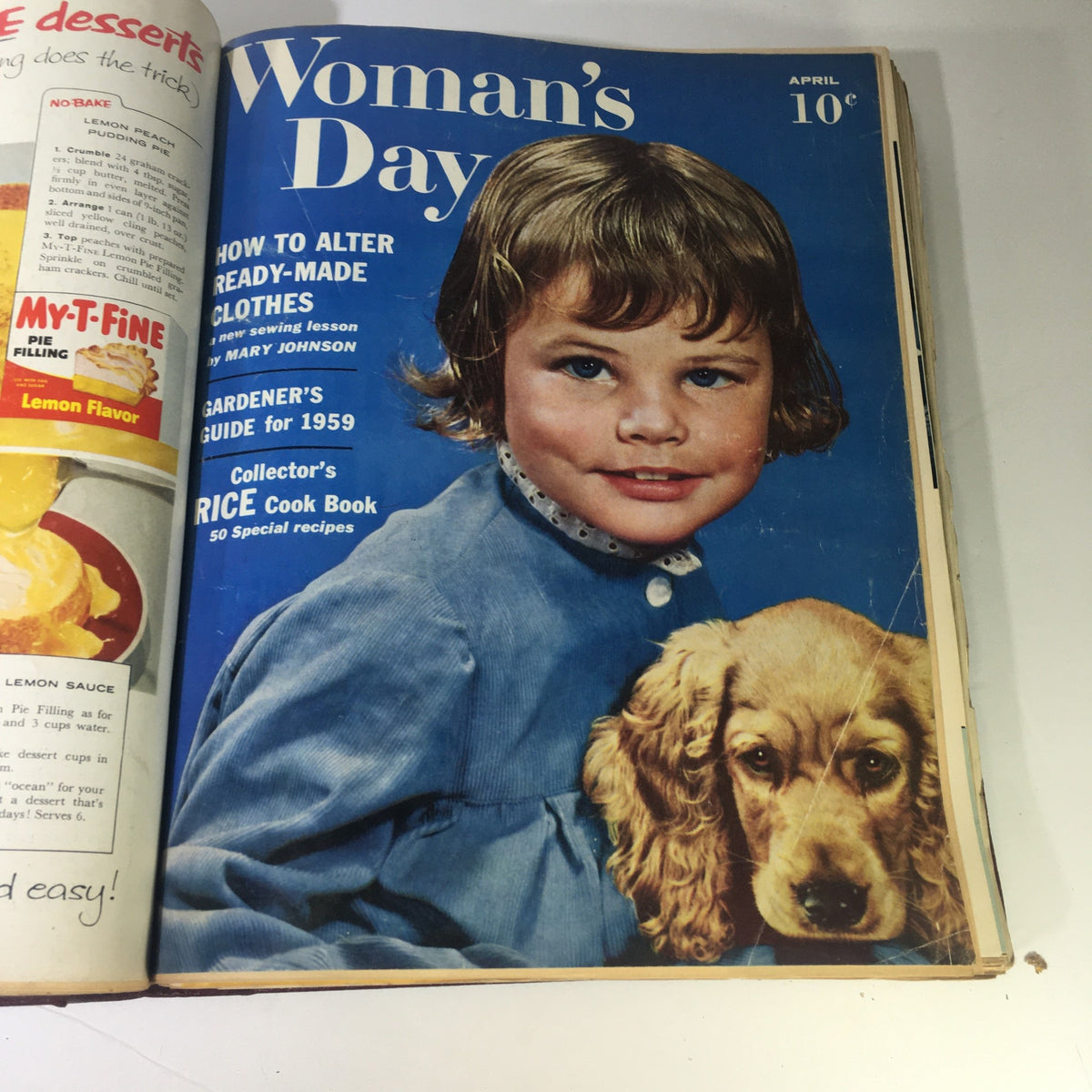 Cover of the April 1959 Woman's Day Magazine featuring a young girl and a puppy, with articles on altering clothes and gardening.
