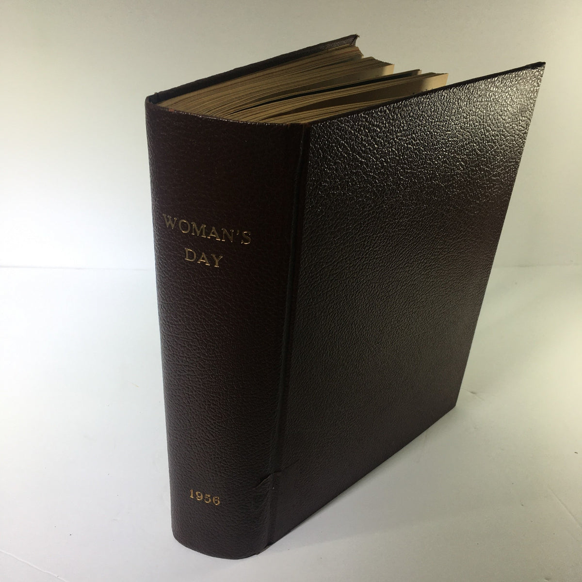Side view of the 1956 Woman's Day Magazine Complete Year Round in One Book Compilation, displaying the title 'WOMAN'S DAY' embossed in gold along with the year 1956.