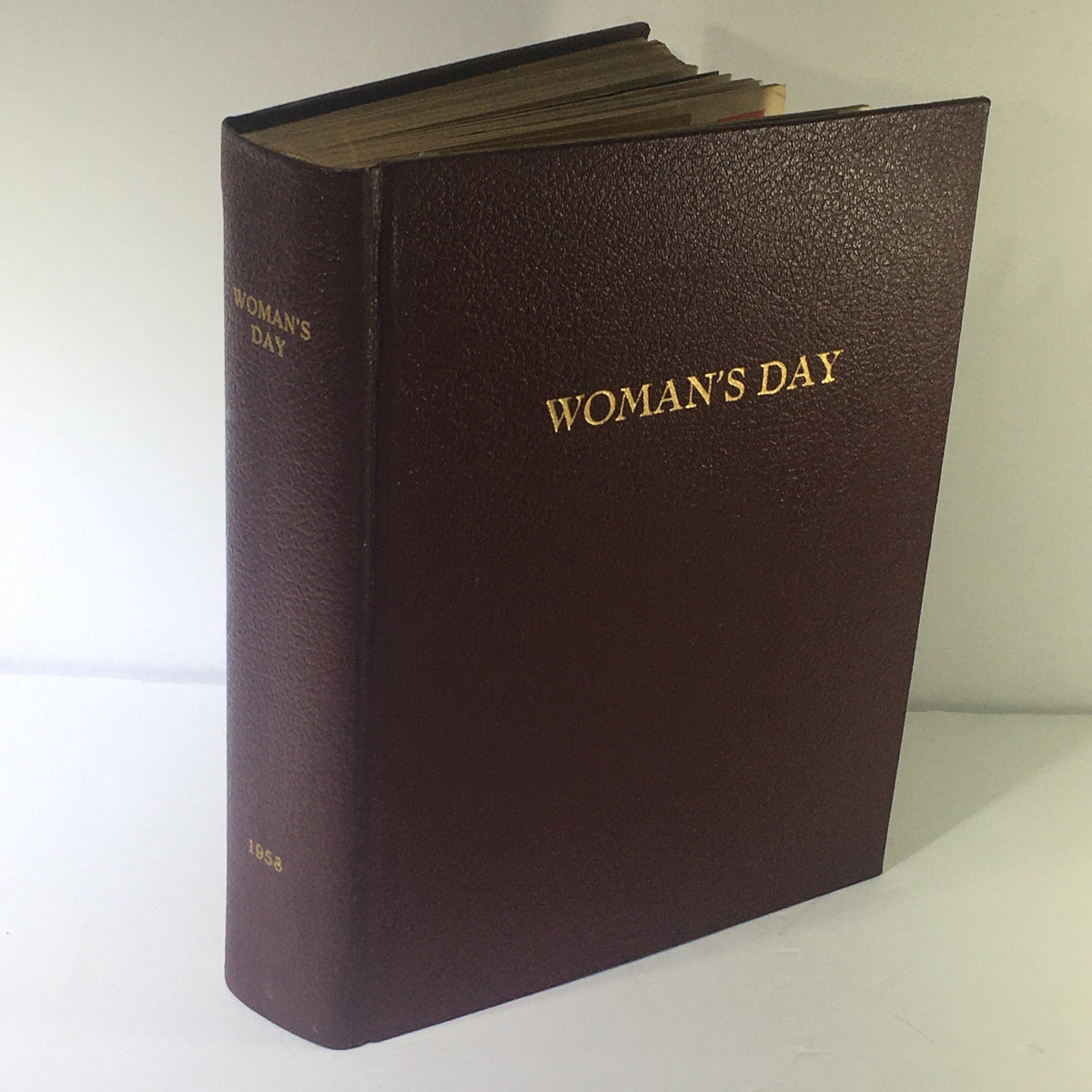 1958 Woman's Day Magazine Compilation cover, showcasing a vintage maroon book with golden lettering.